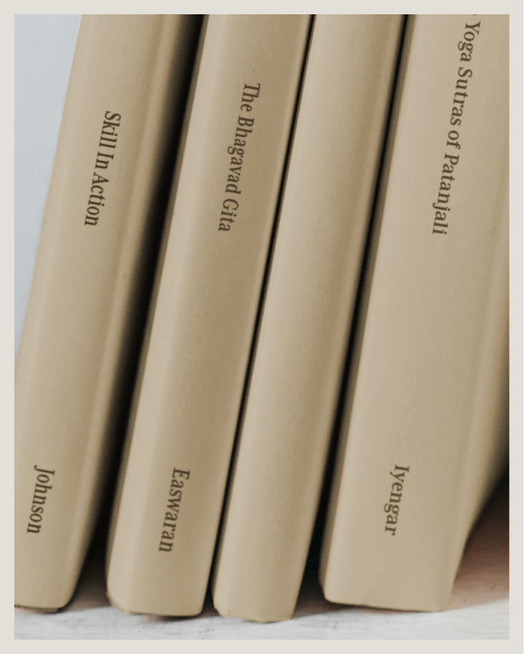 A close-up of five books on a shelf with beige covers and black text on their spines.
