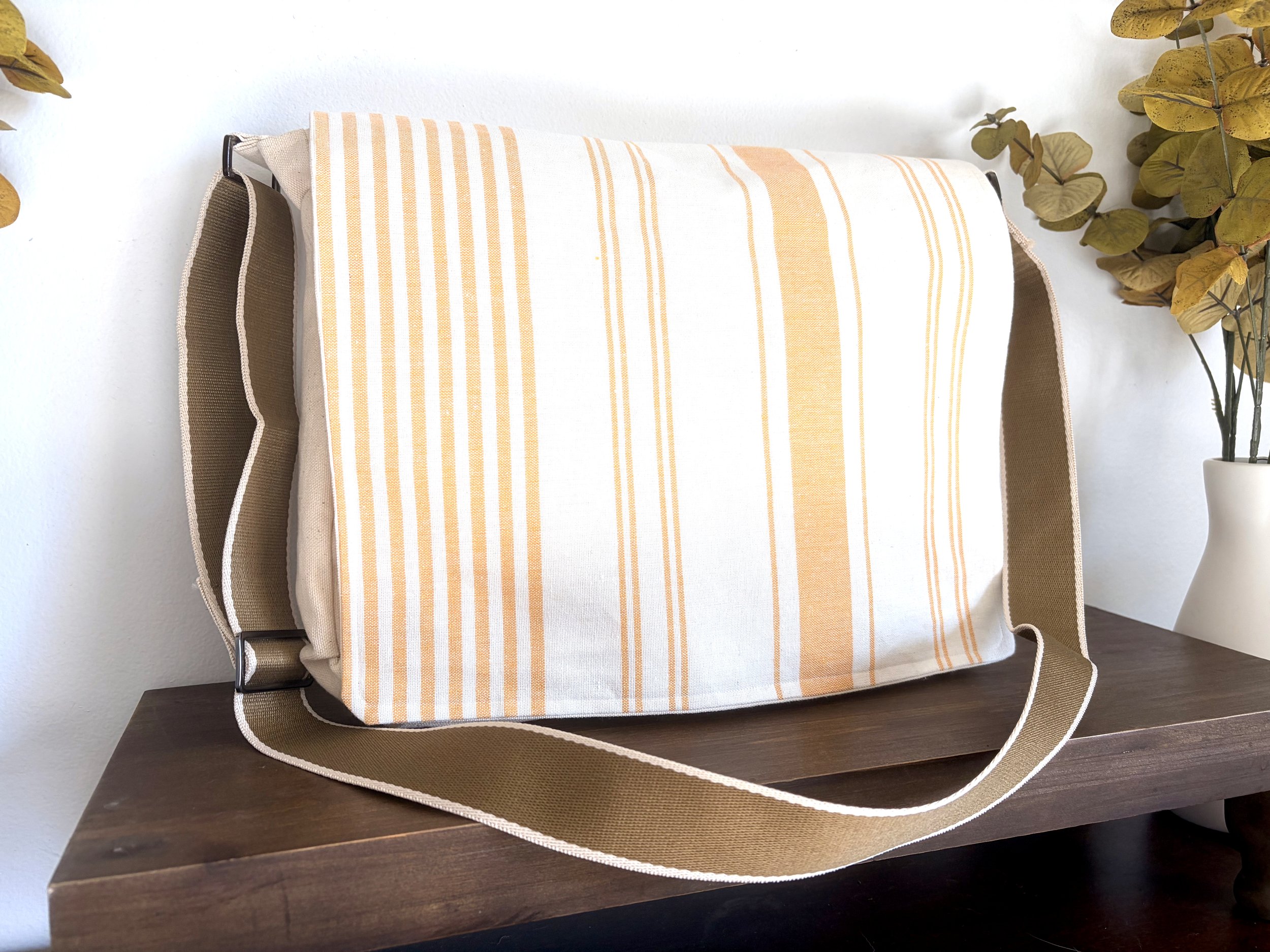Messenger bag. Large enough for most laptops. 6 pockets, including two zippered pockets. 