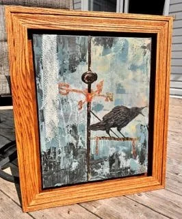painting of a crow on canvas framed with a brown frame