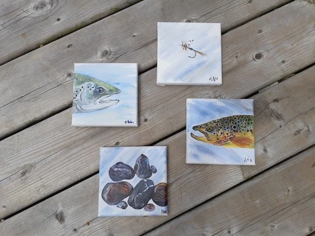 photo of four fish and aquatic themed paintings