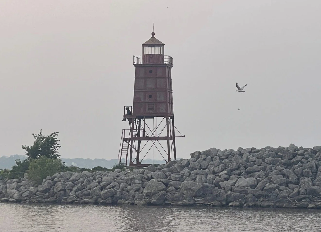 Lake Michigan view of rocks and small lighthouse