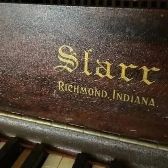 Close-up of a wooden surface with gold lettering reading 'Starr Richmond, Indiana'.