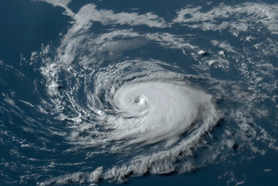 Satellite image of a hurricane with a clear eye and spiral cloud bands.