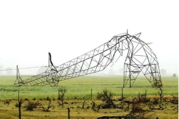 Large metal sculpture of a reclining horse on a grassy field