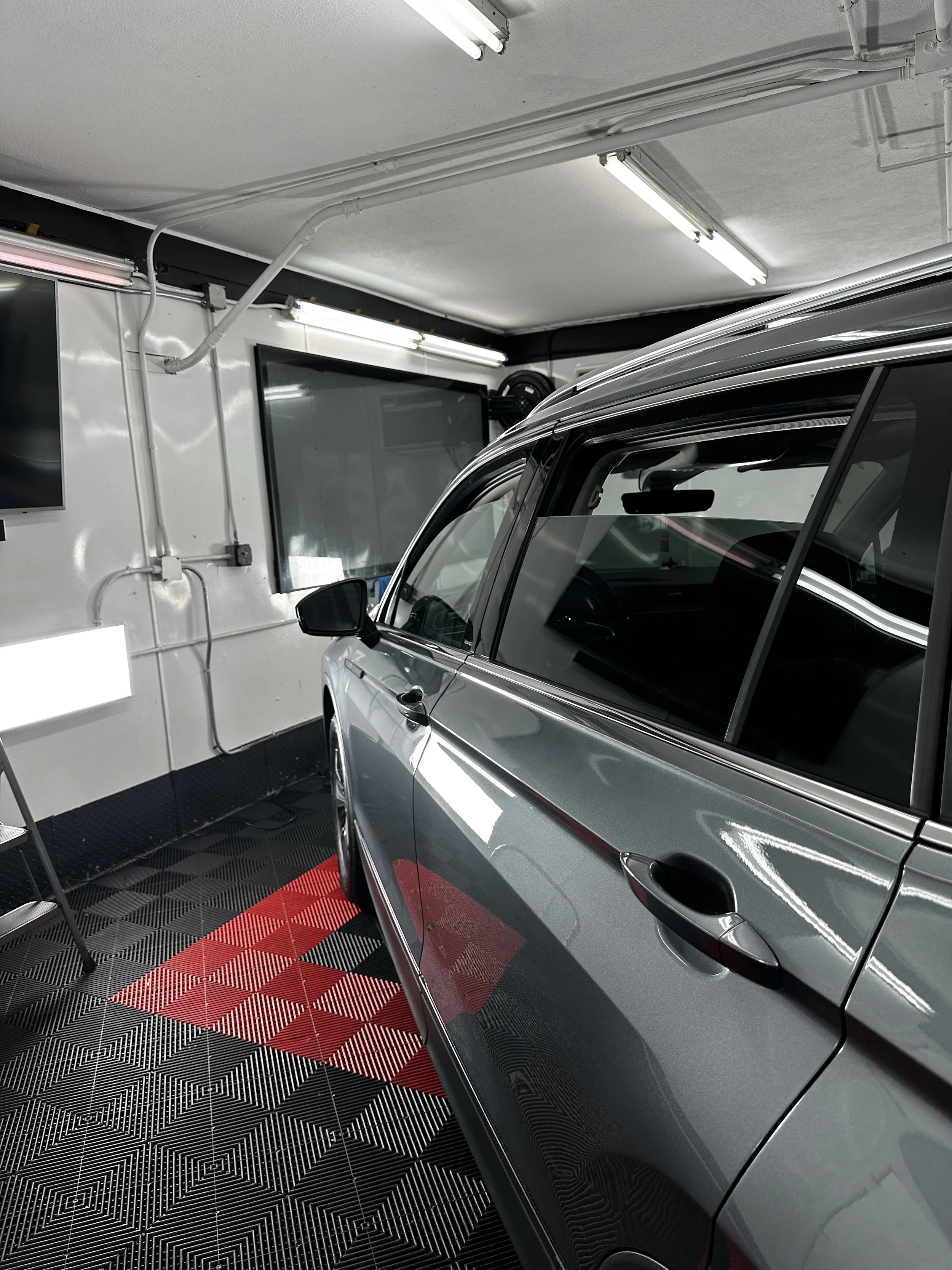 Silver SUV in the Show Form Studio bay in Salem, MA for a detail