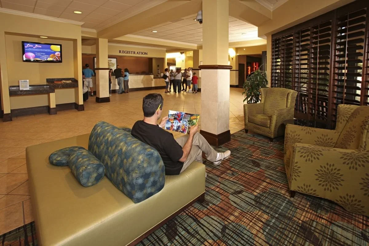 man-lounging-in-the-lobby-at-rosen-inn-at-pointe-orlando.jpg