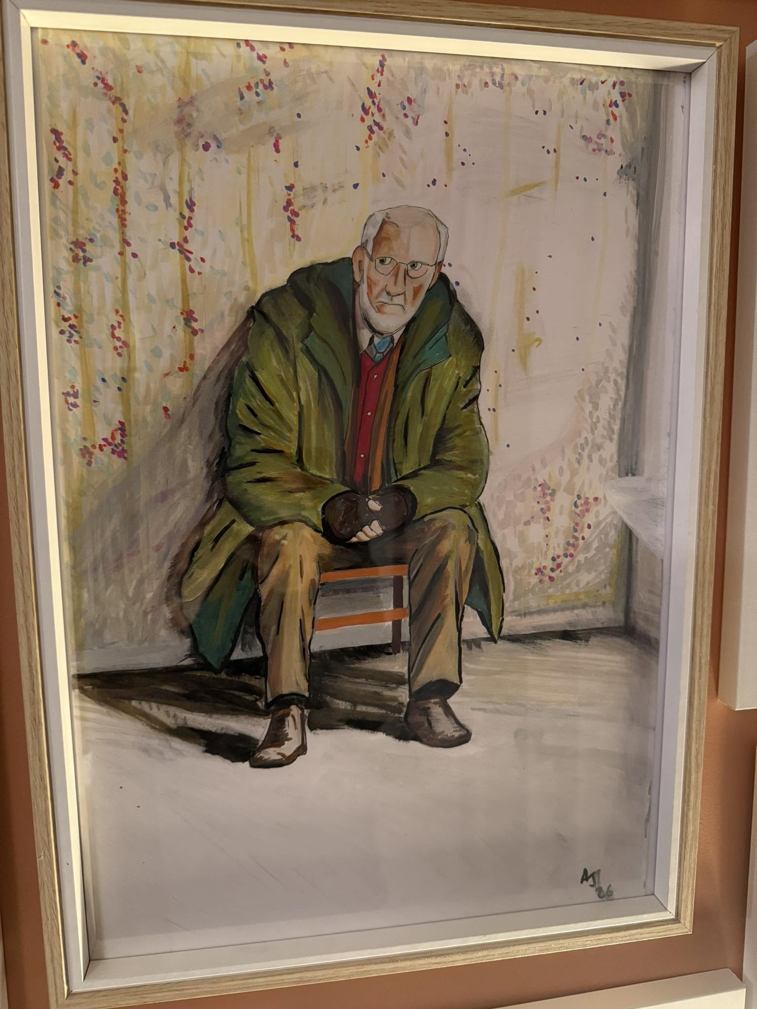 Framed painting of an elderly man sitting on a chair, wearing glasses, a green jacket, and a red shirt with a blue tie, with a background of abstract trees with pink and purple leaves.