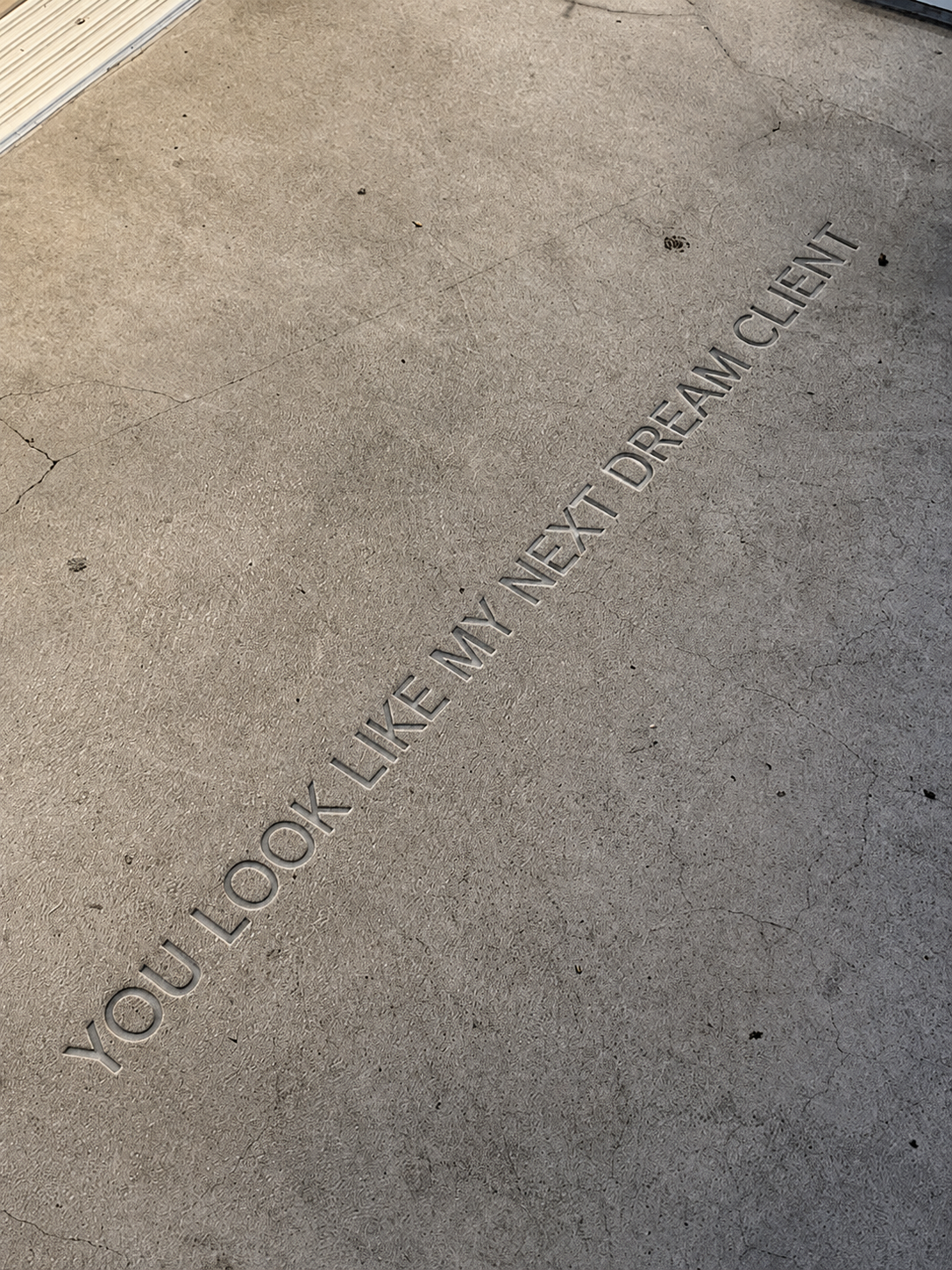 Cracked concrete floor with the words “YOU LOOK LIKE MY NEXT DREAM CLIENT” overlaid diagonally.