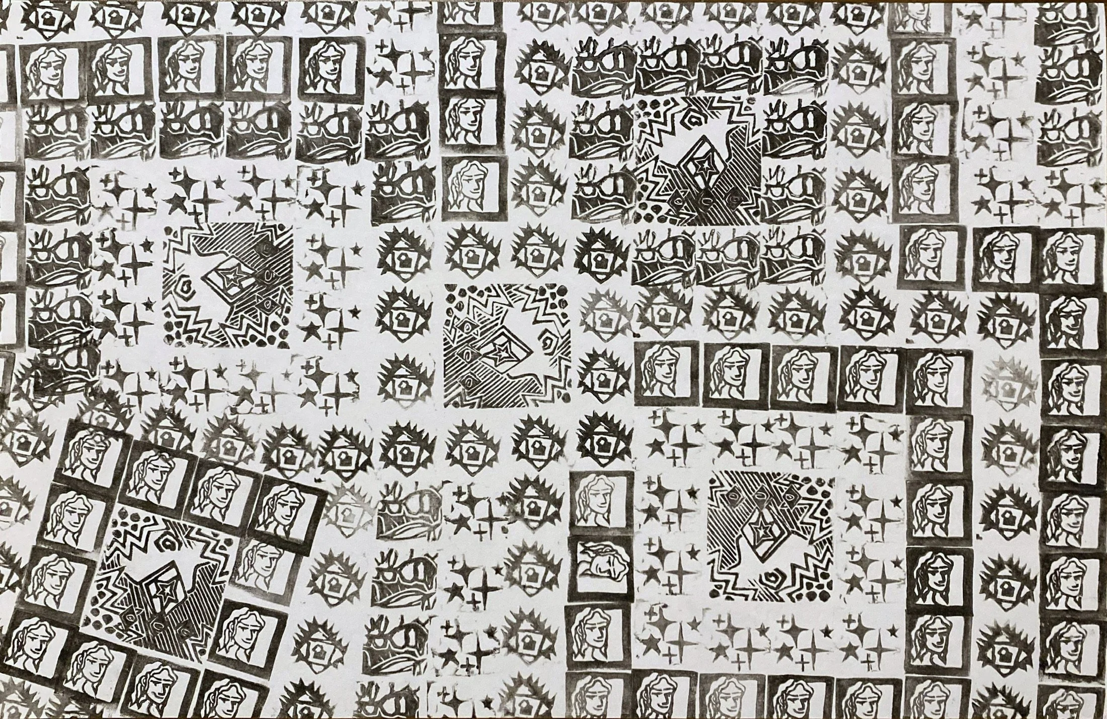 A black and white patterned sheet with repeating images, including a woman's face, stars, and abstract geometric shapes.