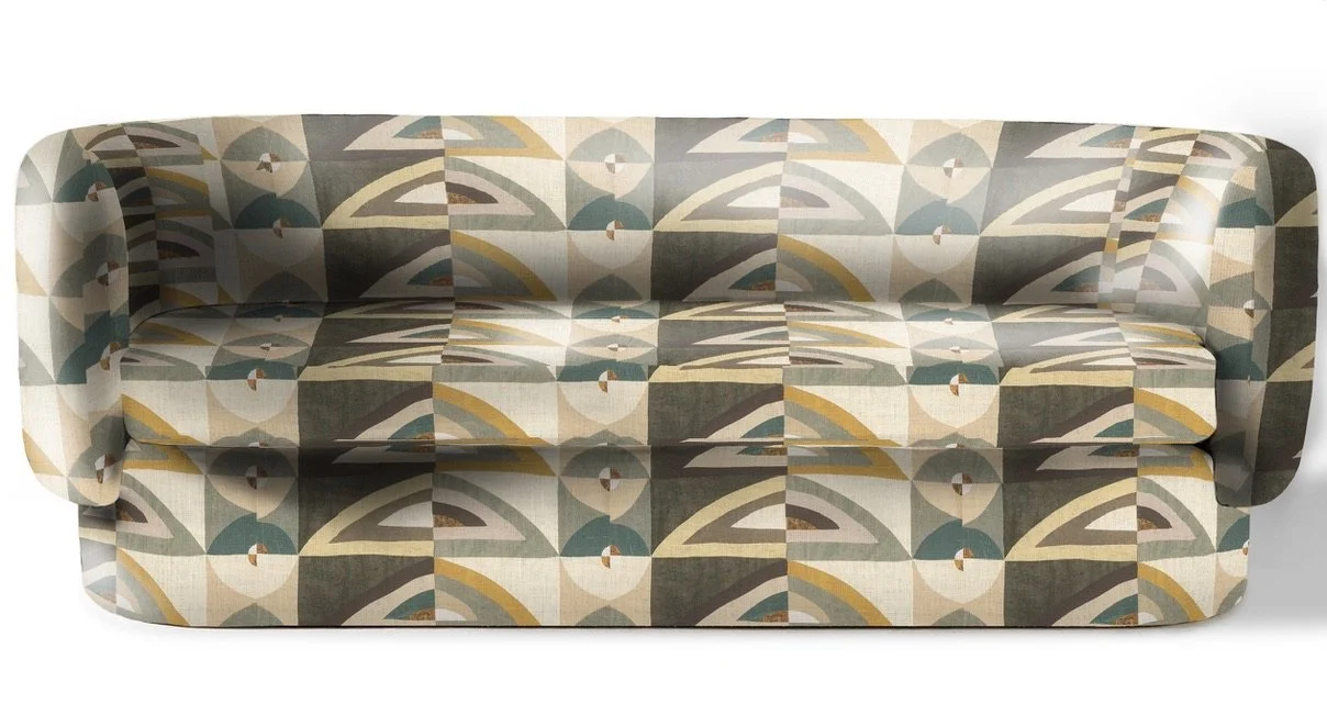 A vintage sofa with a colorful geometric patterned fabric in shades of beige, brown, green, and yellow.