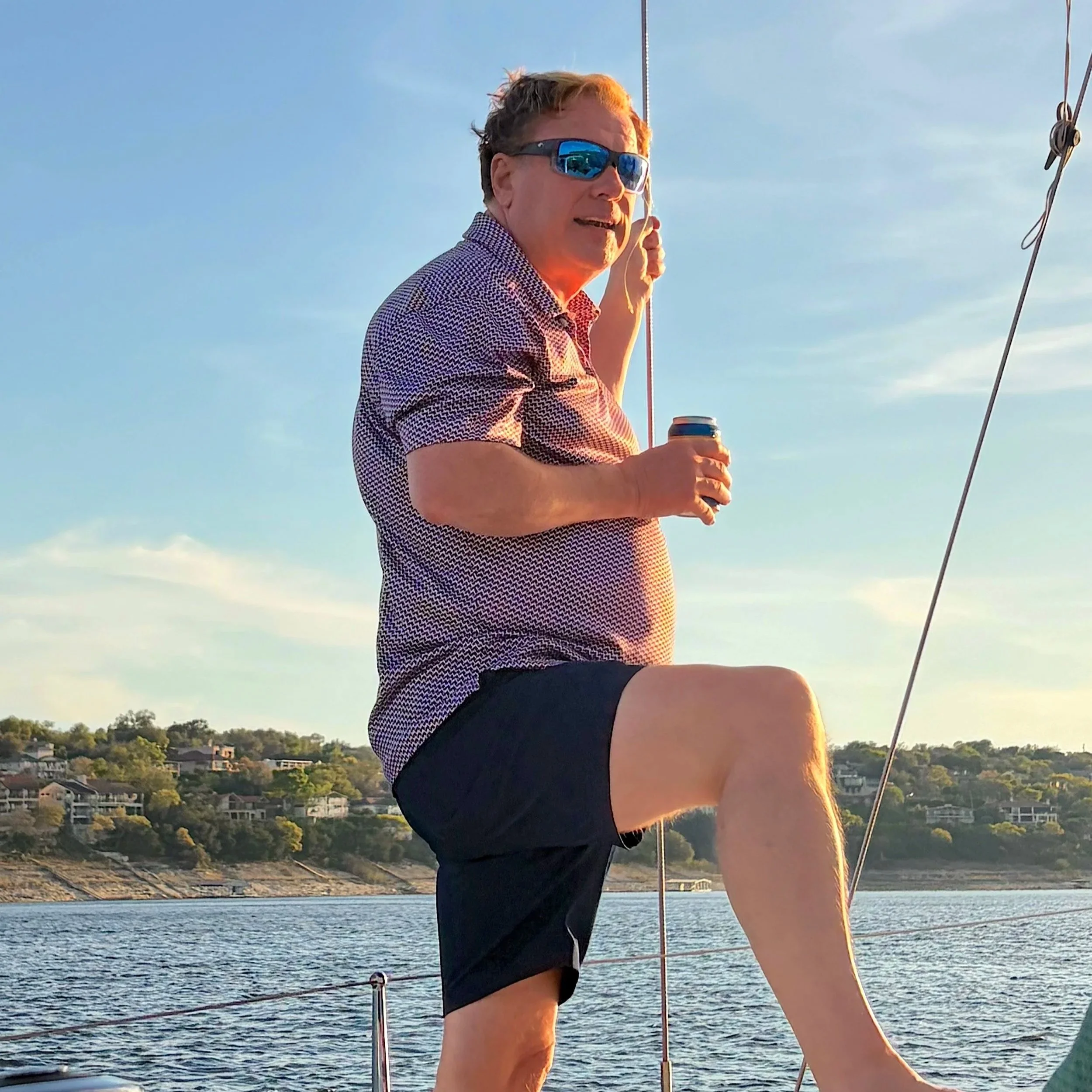 Adult 50+ enjoying time on a boat at sunset.