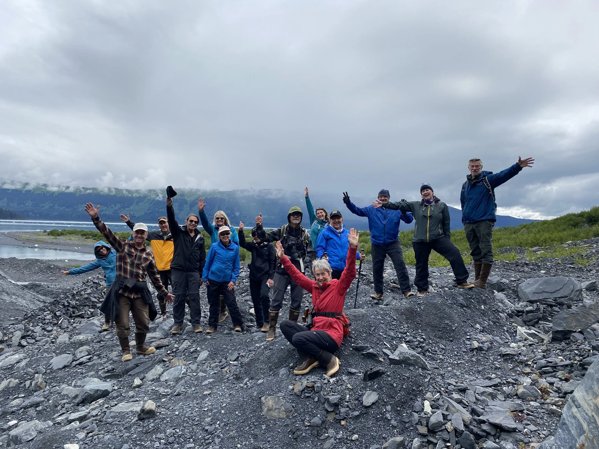 Group of adults hiking together in a mountain landscape.