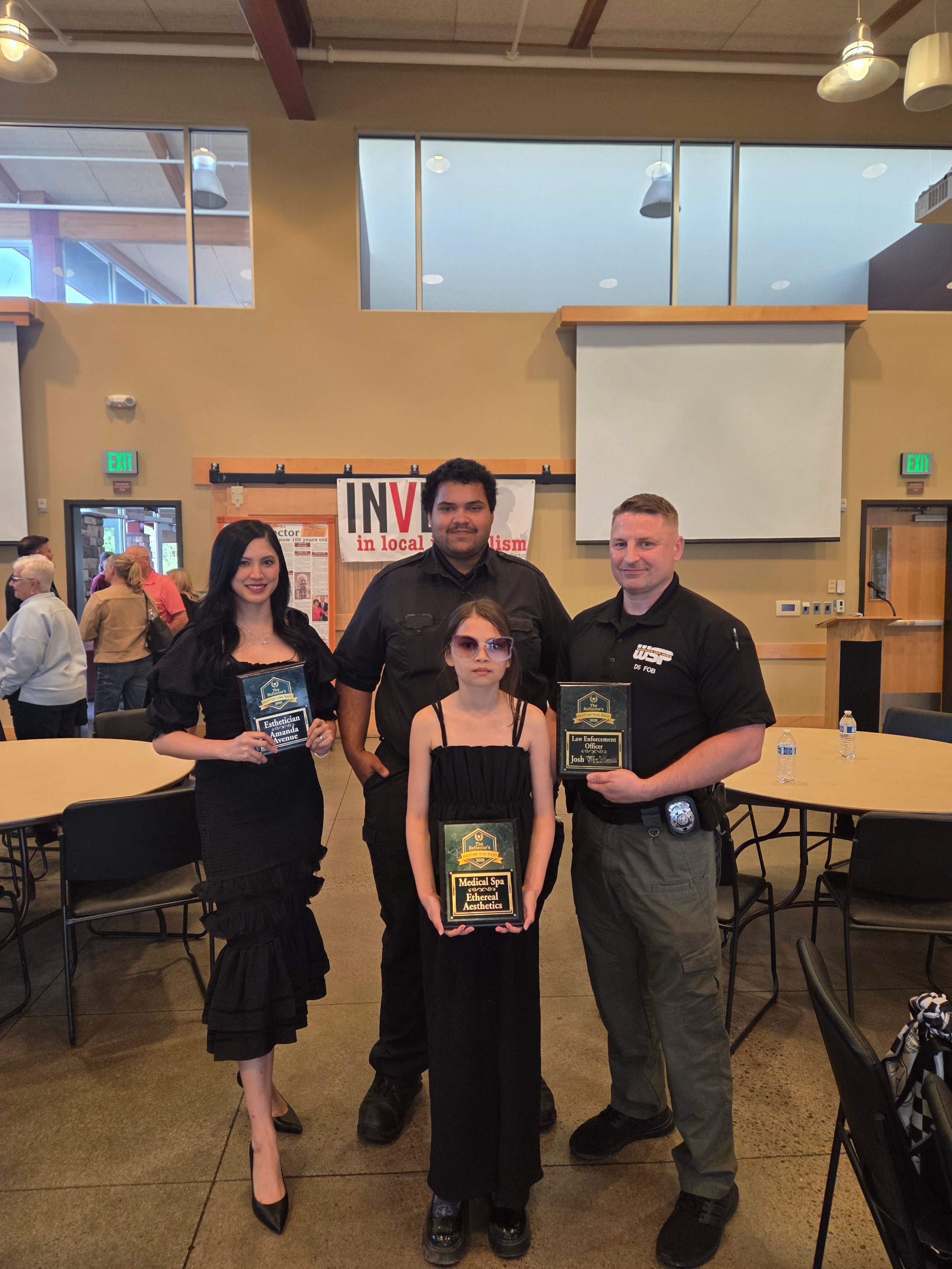 Amanda and her family at an award ceremony for the Reflectors awards best of the best esthetician in Battleground, WA
