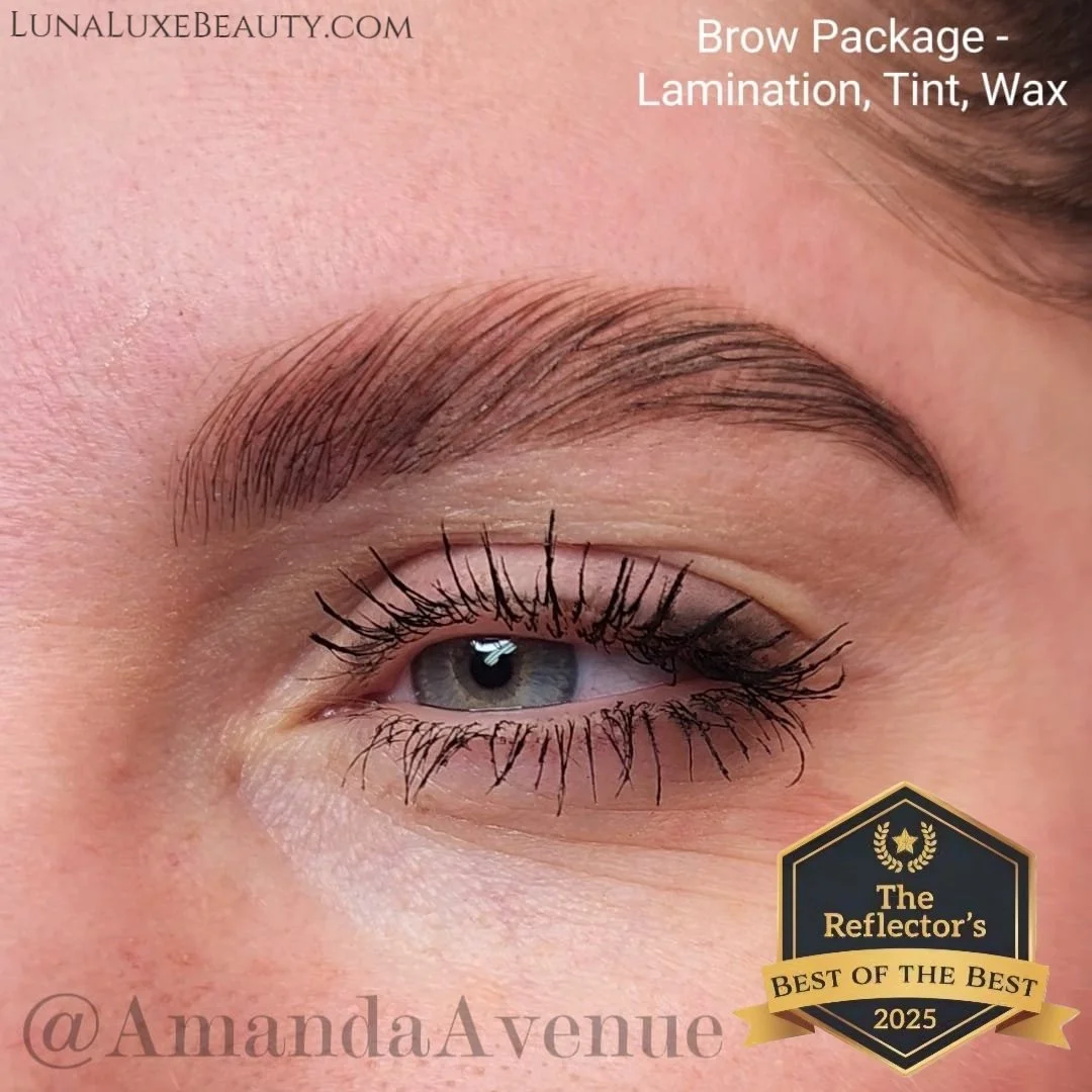 Close-up of a woman's eye with well-groomed eyebrow, mascara-coated lashes, and eyelid with subtle eyeshadow. Text overlays mention brow package with lamination, tint, and wax, and celebrate the image as a reflection's 'Best of the Best 2025' award.
