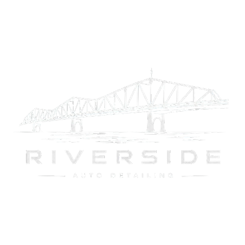 Logo for Riverside Auto Dealings featuring a white outline of a bridge with the company name underneath.