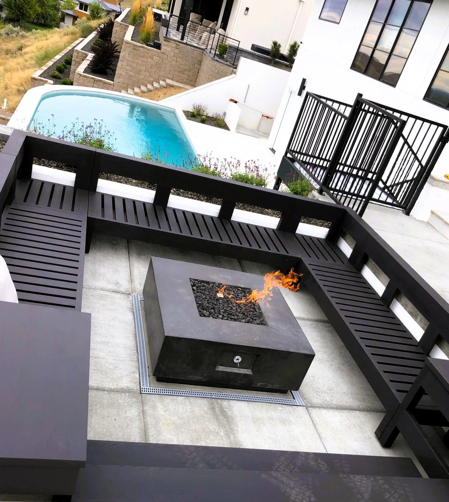 Firepit deck and seating complements a beautiful patio.  