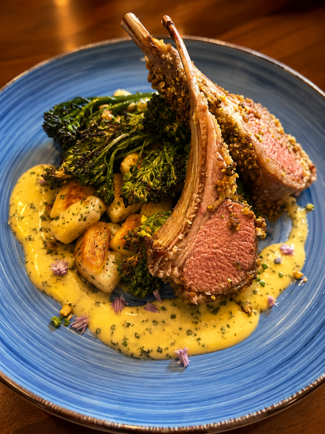 Herb-crusted rack of lamb with roasted potatoes, broccolini, and saffron herb sauce by Chef Amanda
