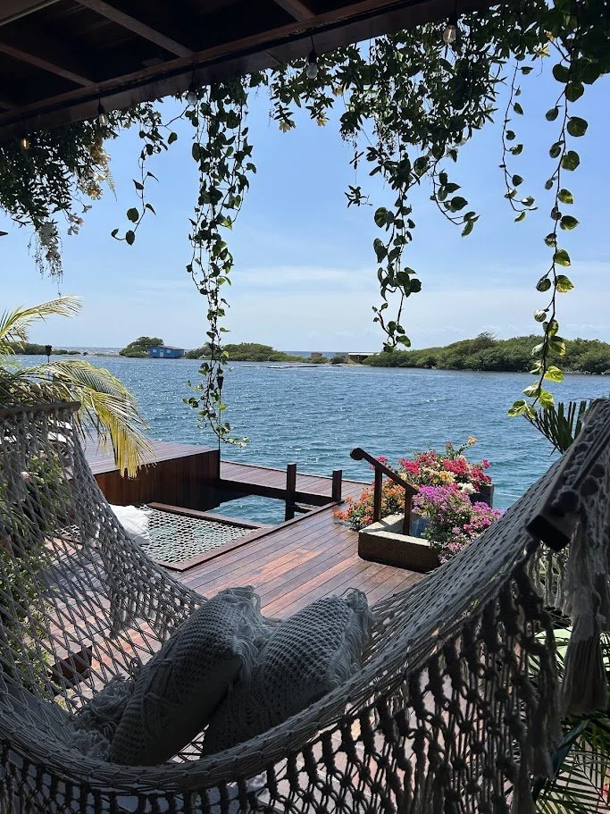 Over the water bungalow with a hammock on the porch in Aruba. 