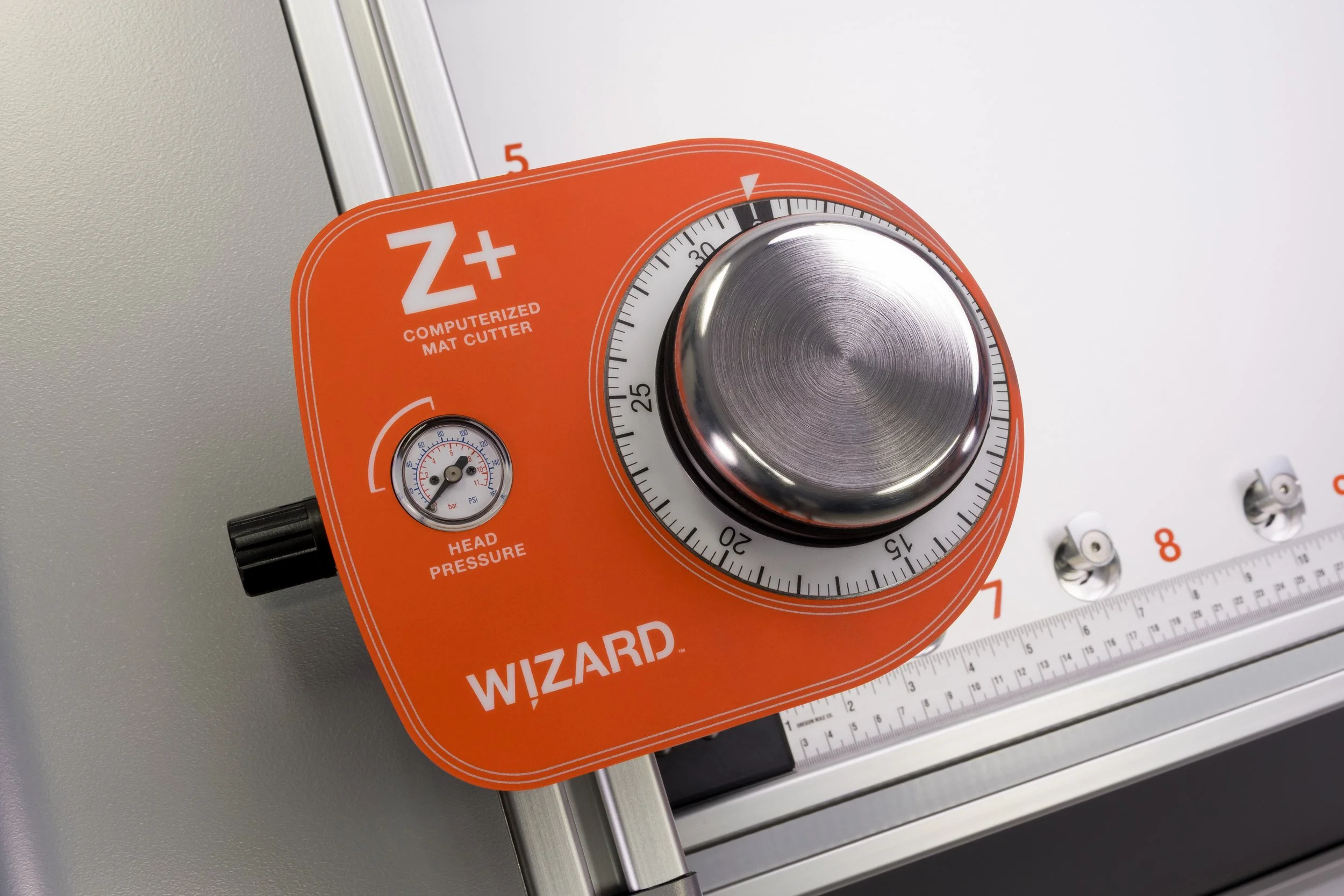 Close-up of the orange Wizard Z+ cutting head and adjustment dial.