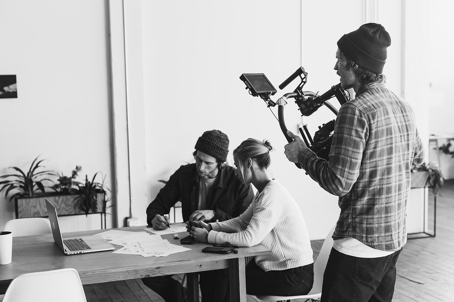 Behind-the-scenes Moment video production with two subjects and a camera operator on set.