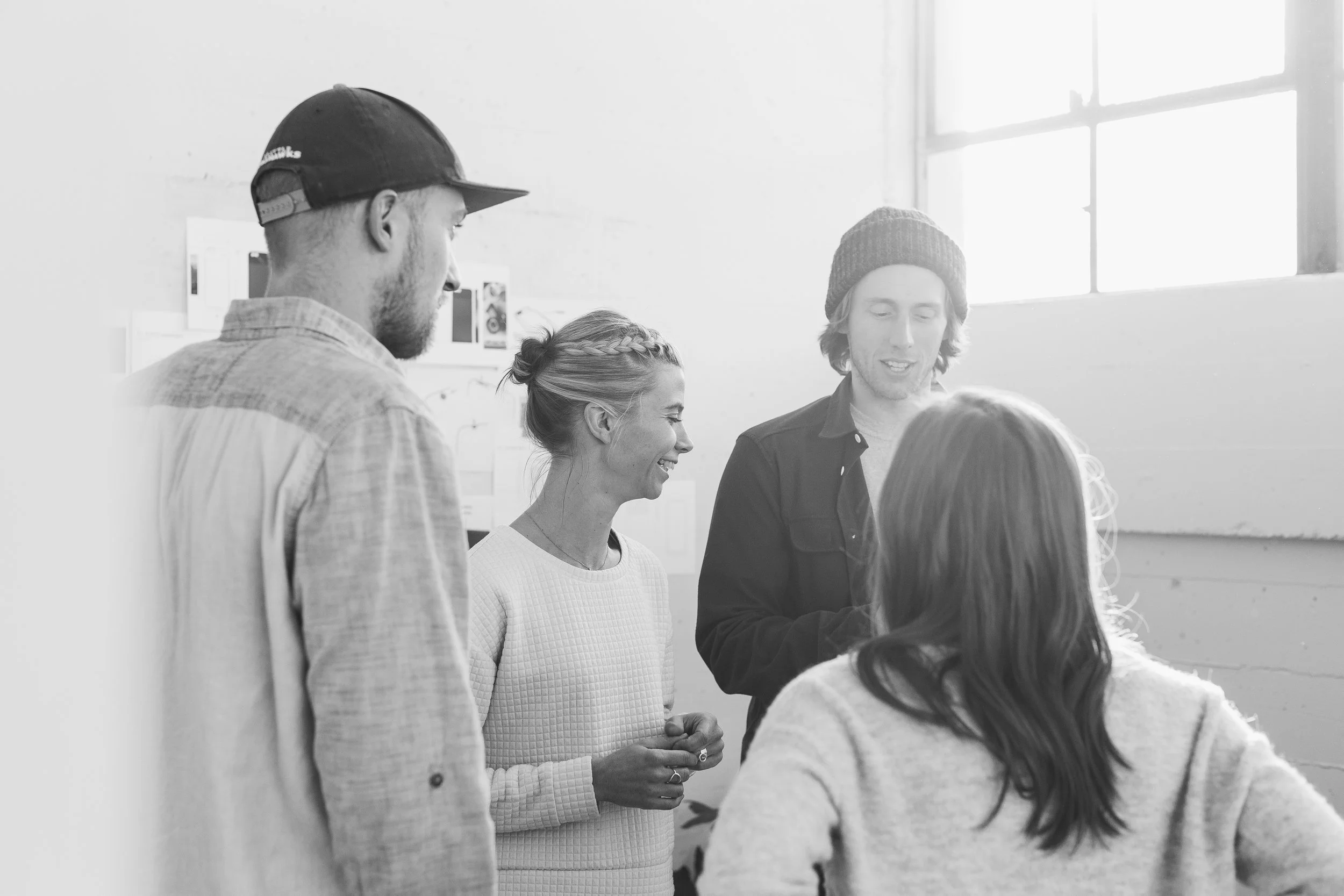 Moment team members discussing a project together in a studio.