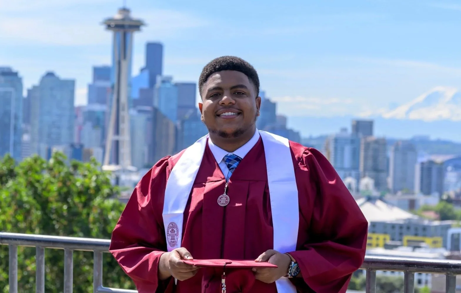 Seattle graduation portrait with the Space Needle and city skyline in the background.