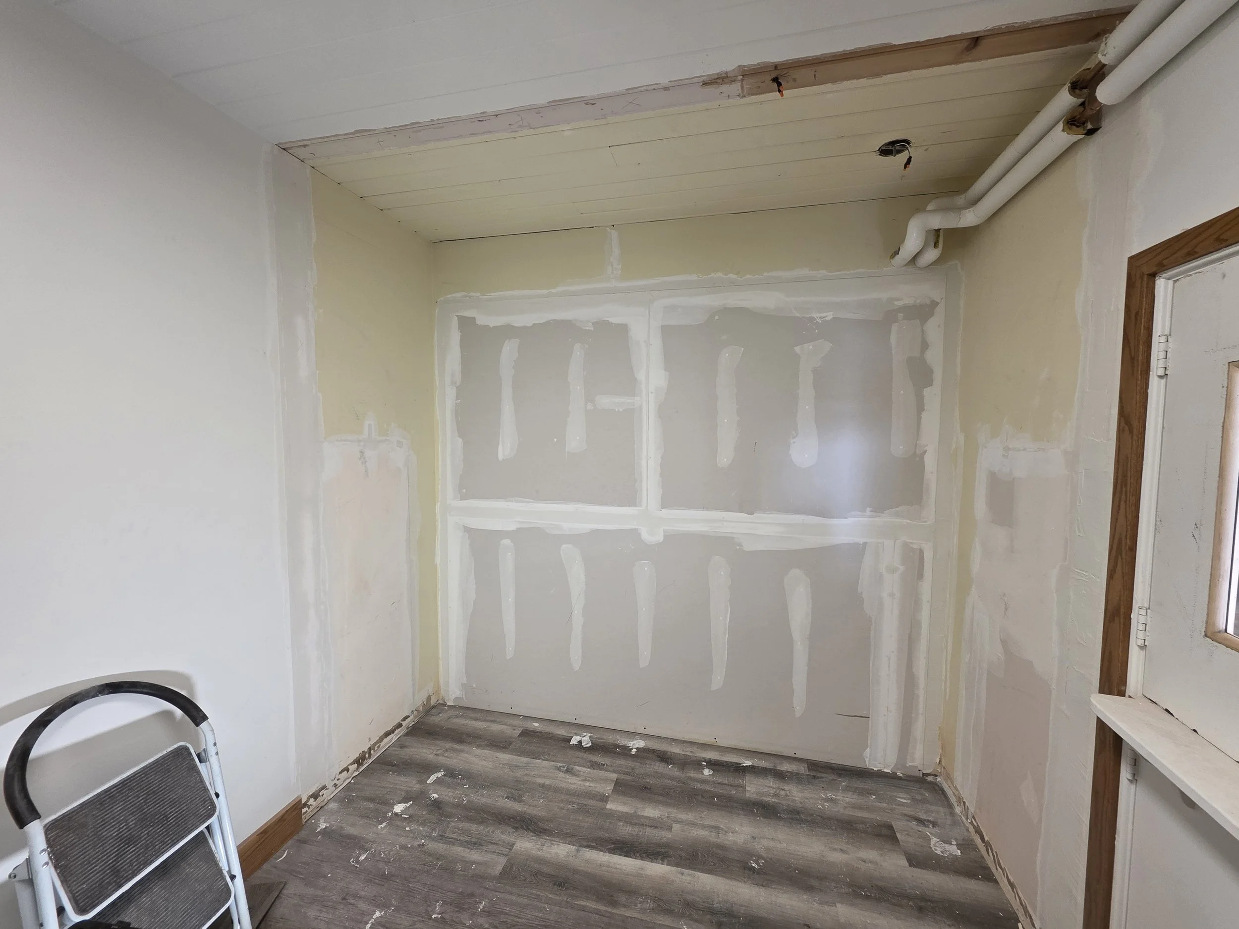 New drywall taped and mudded on the church office wall, Butte, Montana
