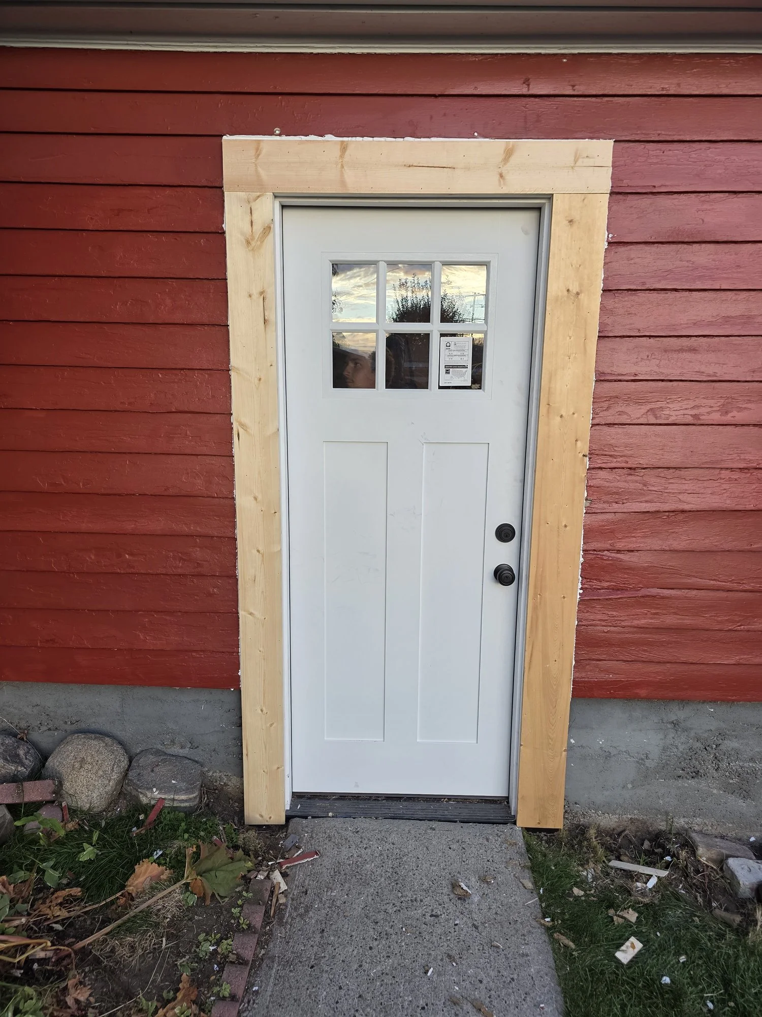 New pre-hung steel garage entry door installed and trimmed, exterior view, Butte, MT
