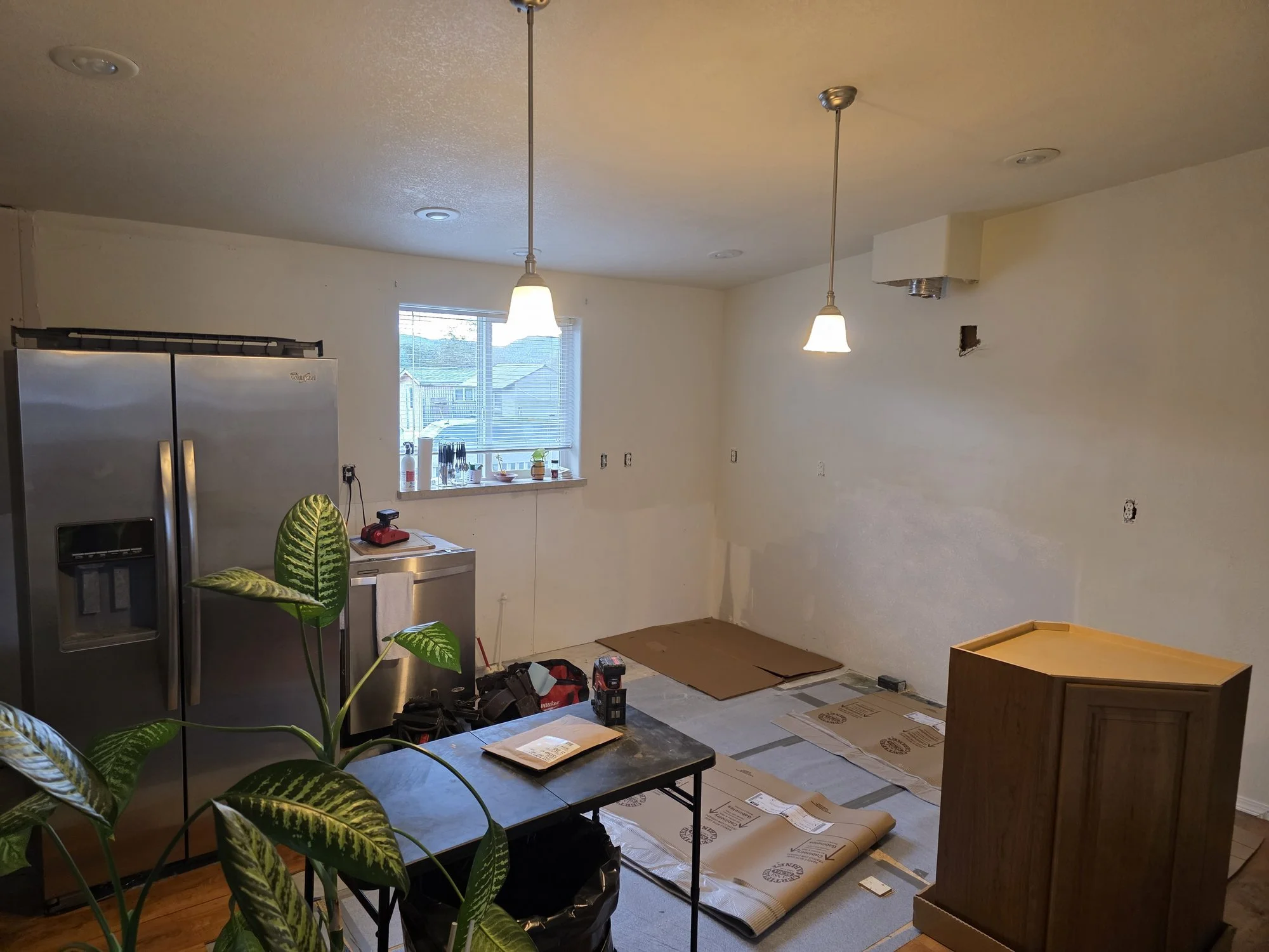 Kitchen stripped to bare walls and subfloor after a fire and water leak, Anaconda, Montana
