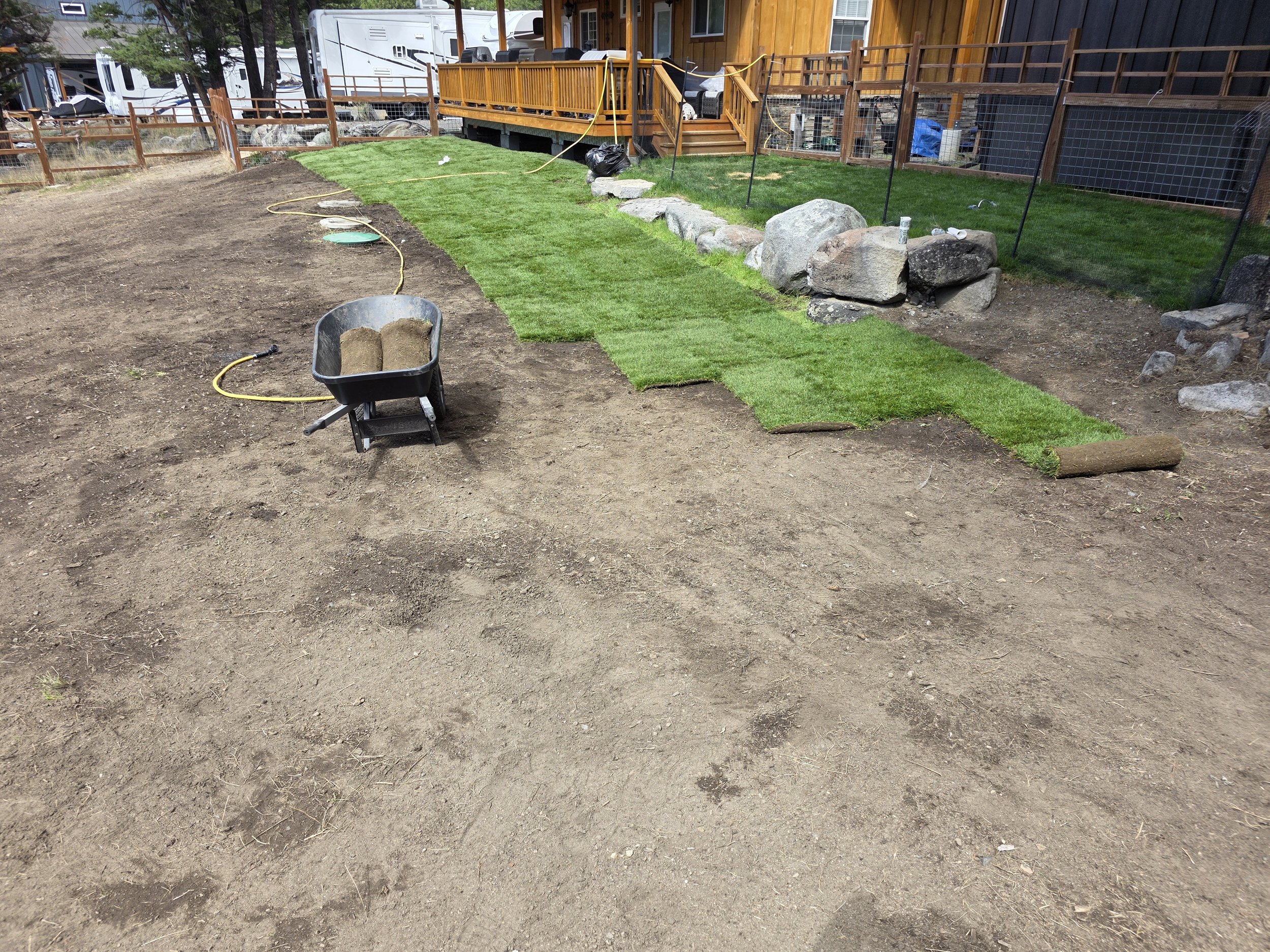 Laying sod rolls across the graded yard, Whitehall, Montana