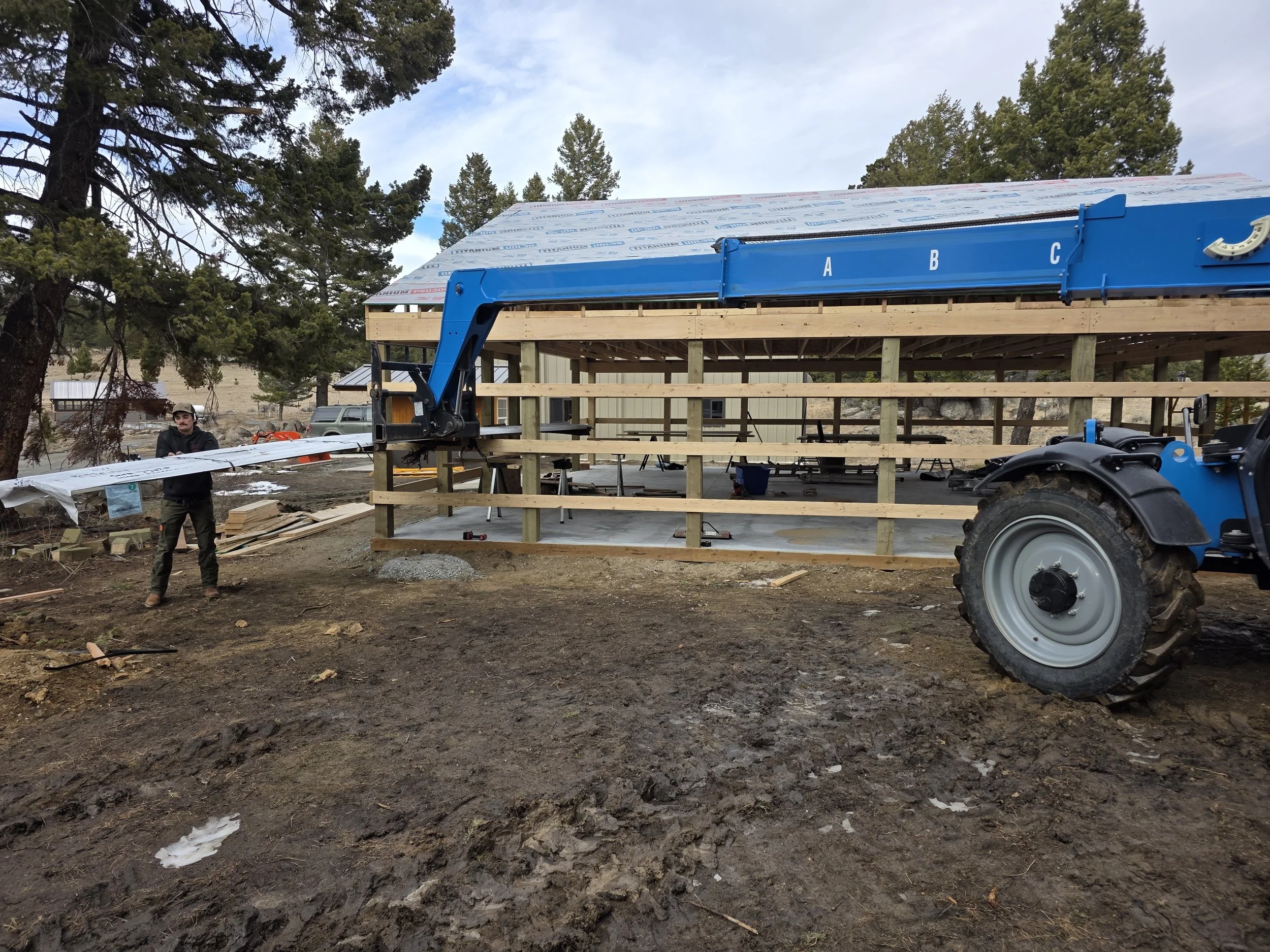 Pole barn construction building with heavy equipment near Whitehall, MT.