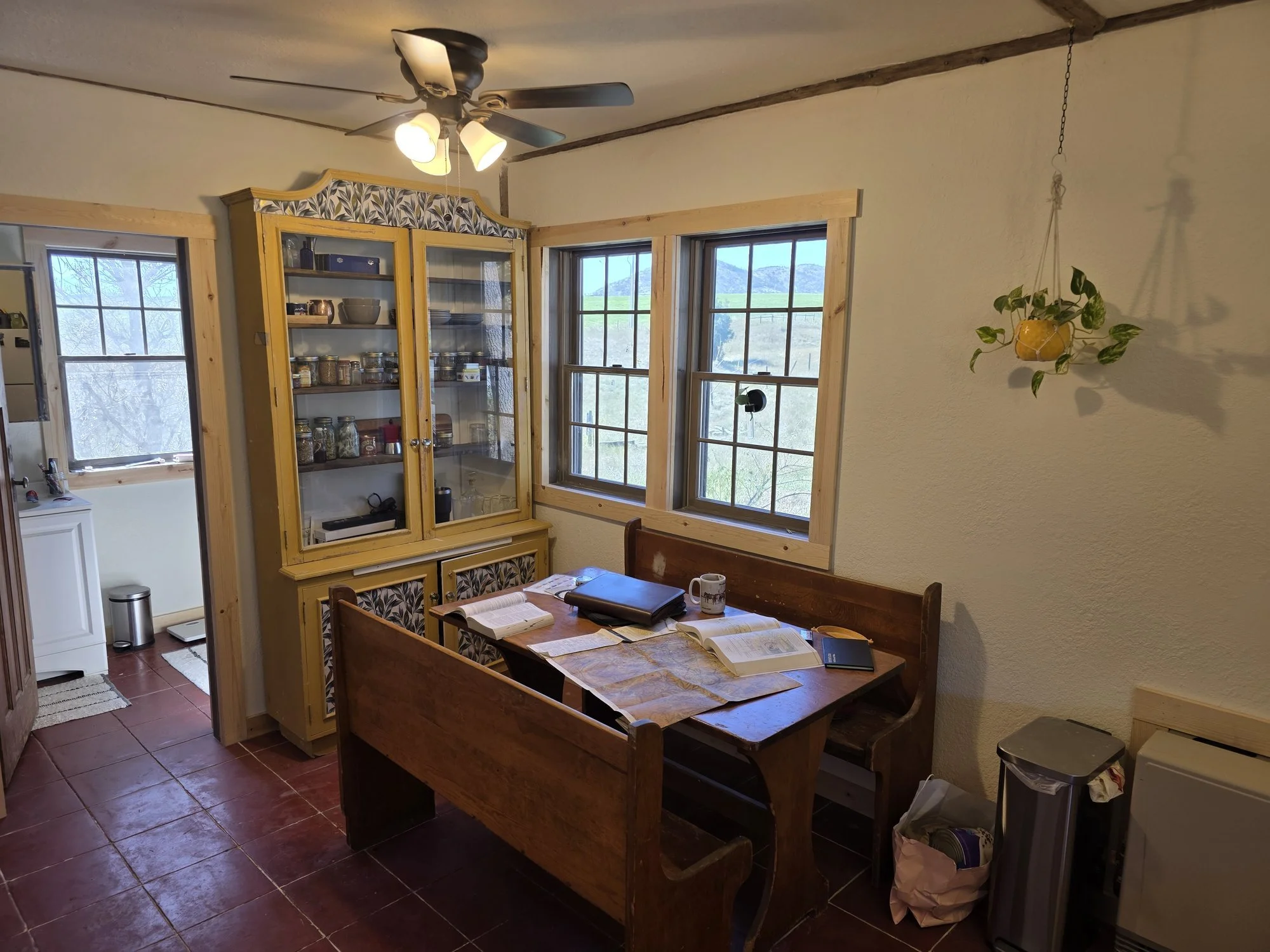 Dining area windows with new casing and a church pew bench, Cardwell, Montana bunkhouse