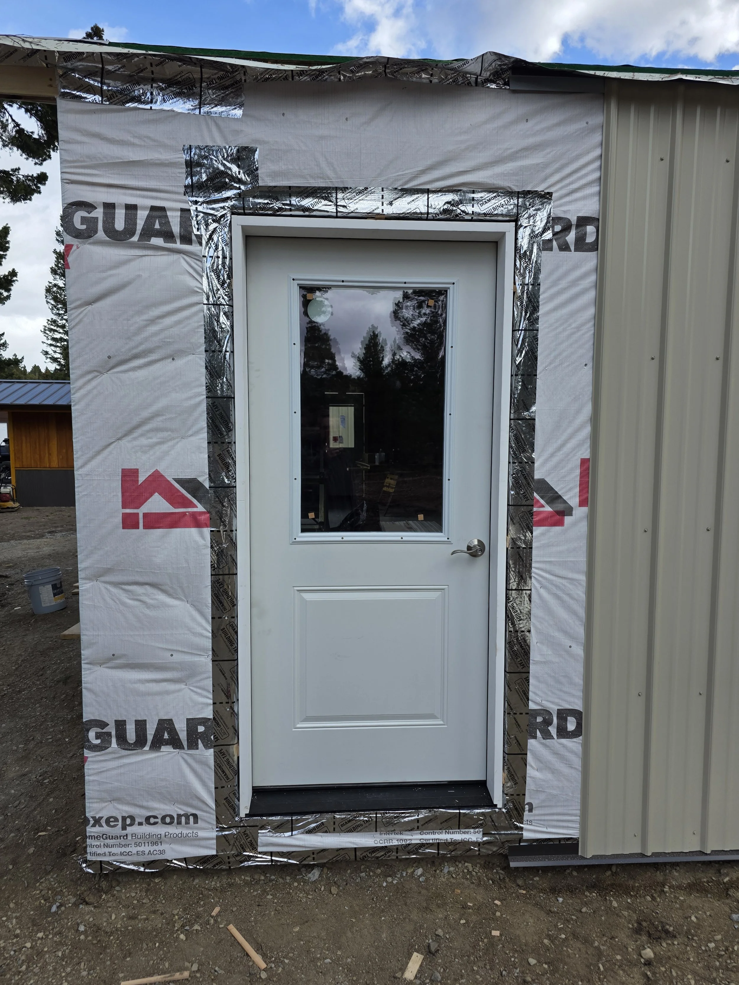 Entry door installed with house wrap and flashing tape, Whitehall, Montana