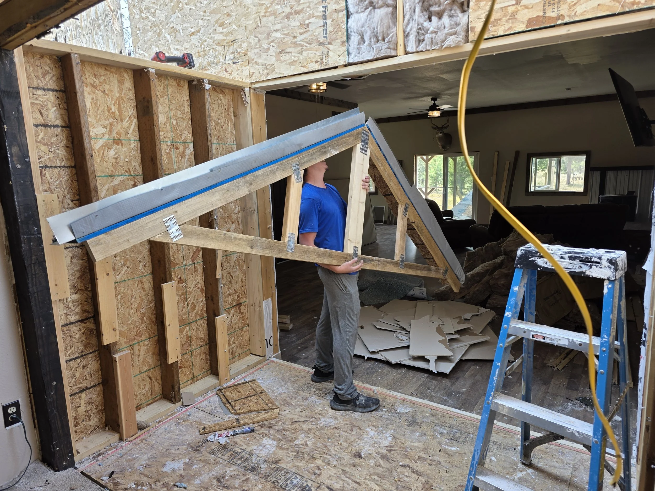 Carrying out a roof truss section during the addition tear-out, Whitehall, Montana