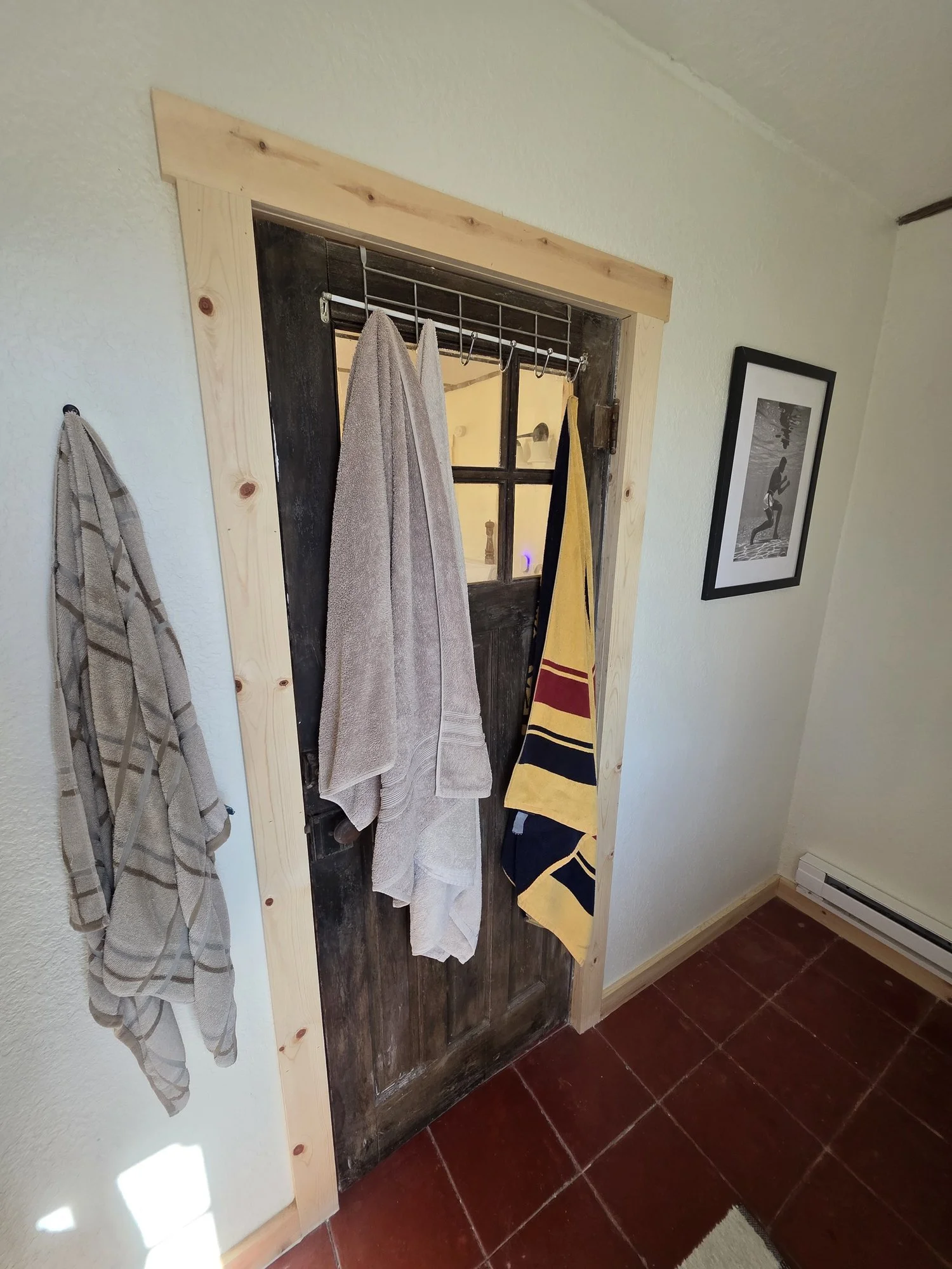 Reclaimed door hung with new pine trim in a renovated Cardwell, Montana bunkhouse