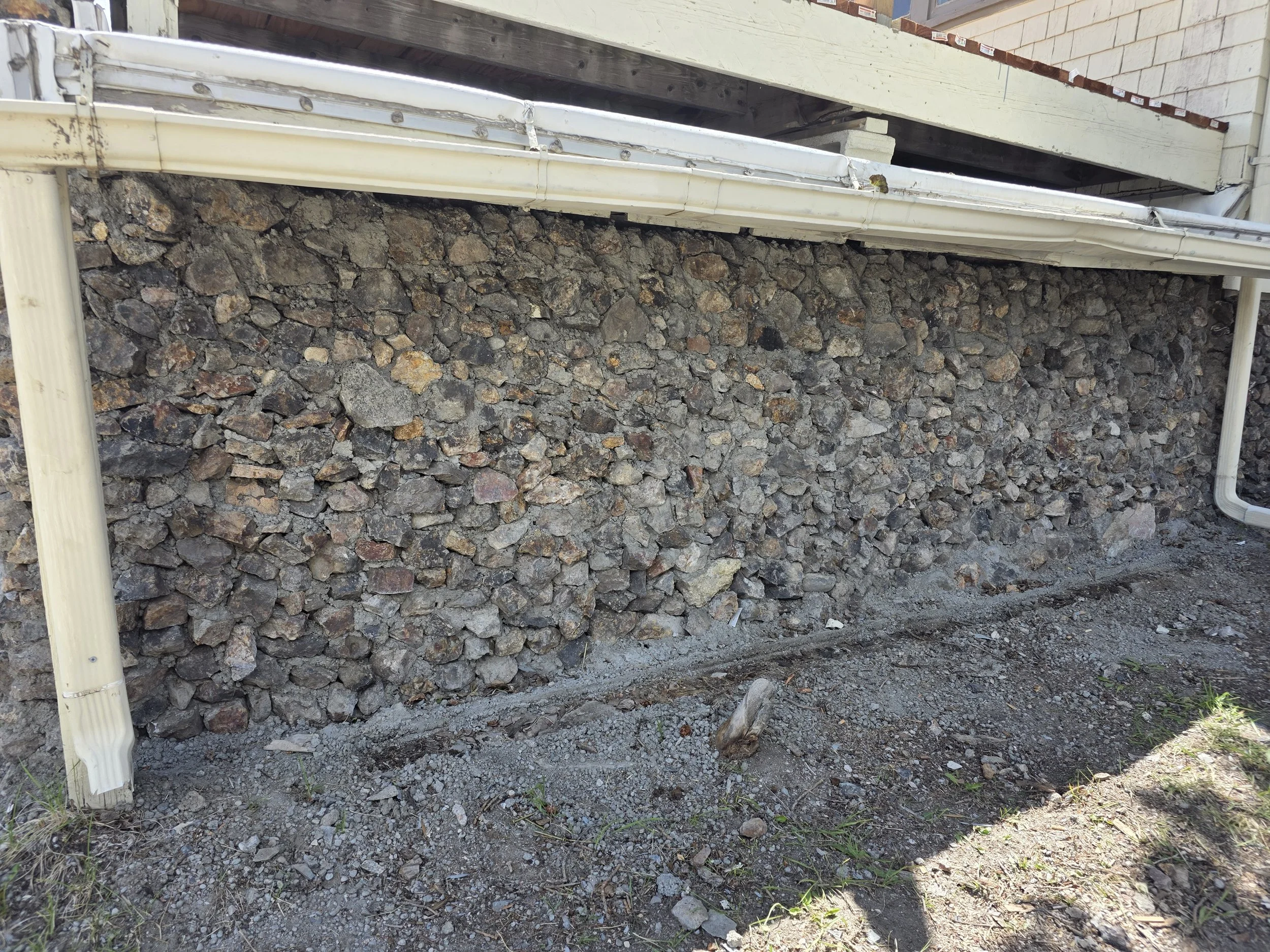 Finished garage wall with the original rock reset in mortar, Butte, Montana