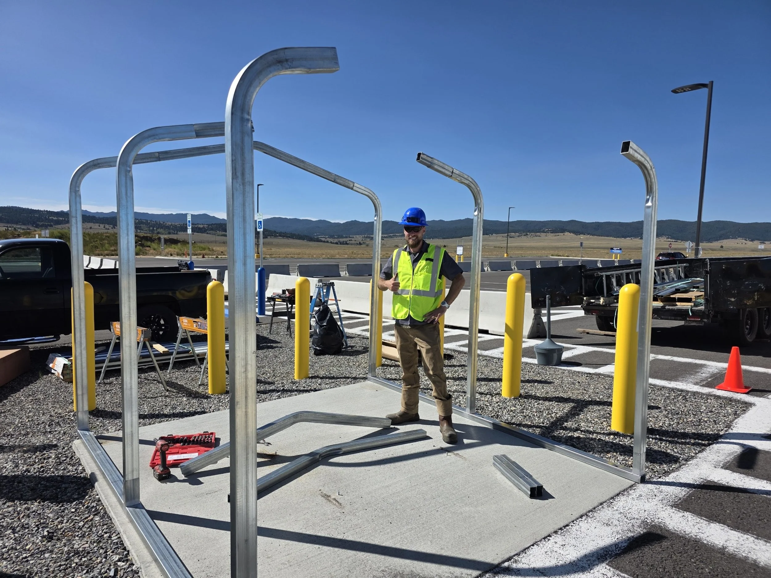 Handy Home Solutions crew member in a hard hat on a steel building job site in Butte, MT