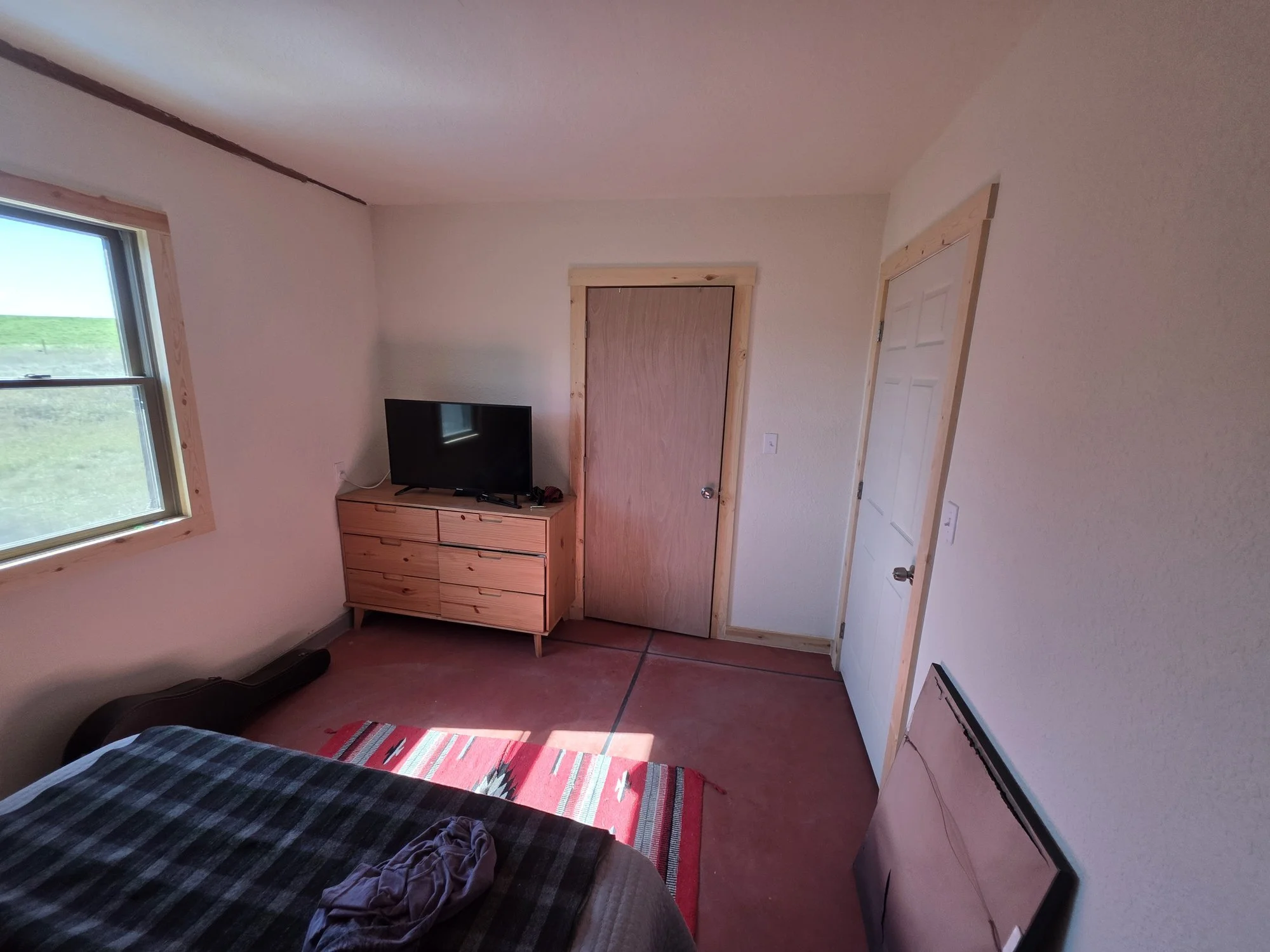 New bedroom doors and window trim in a renovated bunkhouse near Cardwell, Montana