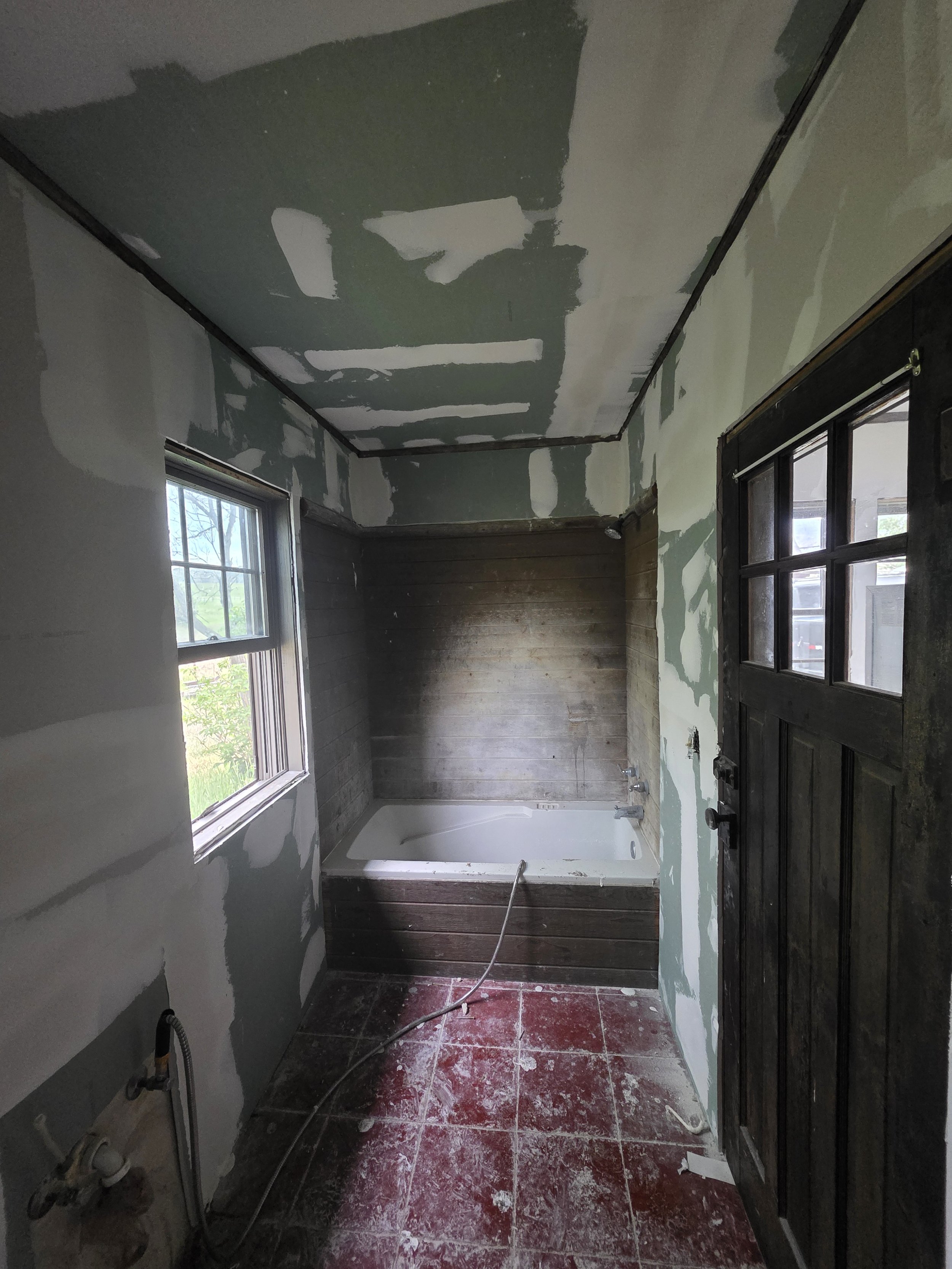 Bathroom drywall taped and mudded around the tub, Cardwell, Montana bunkhouse