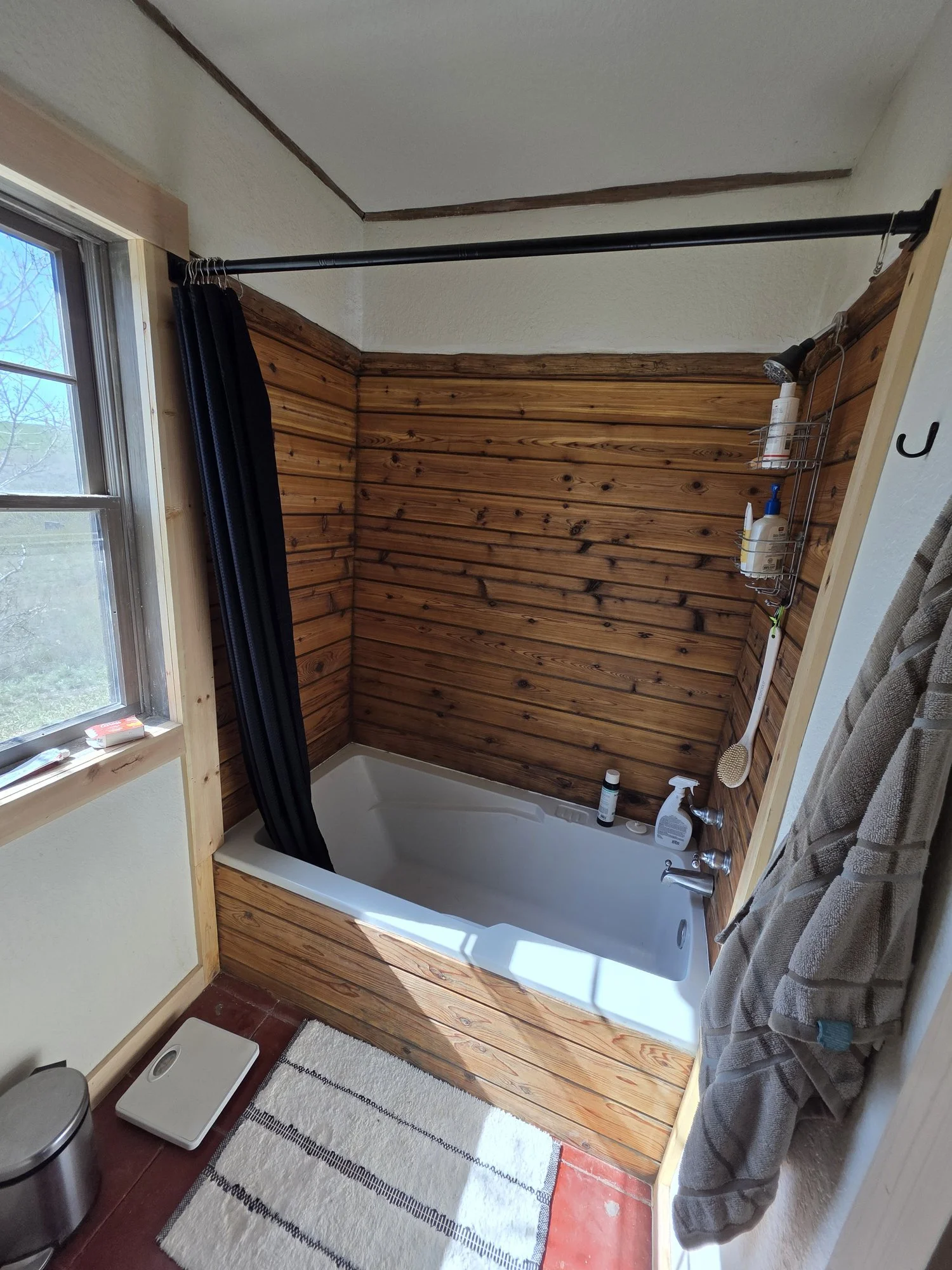 Original bathtub kept and finished with a new wood surround, Cardwell, Montana bunkhouse