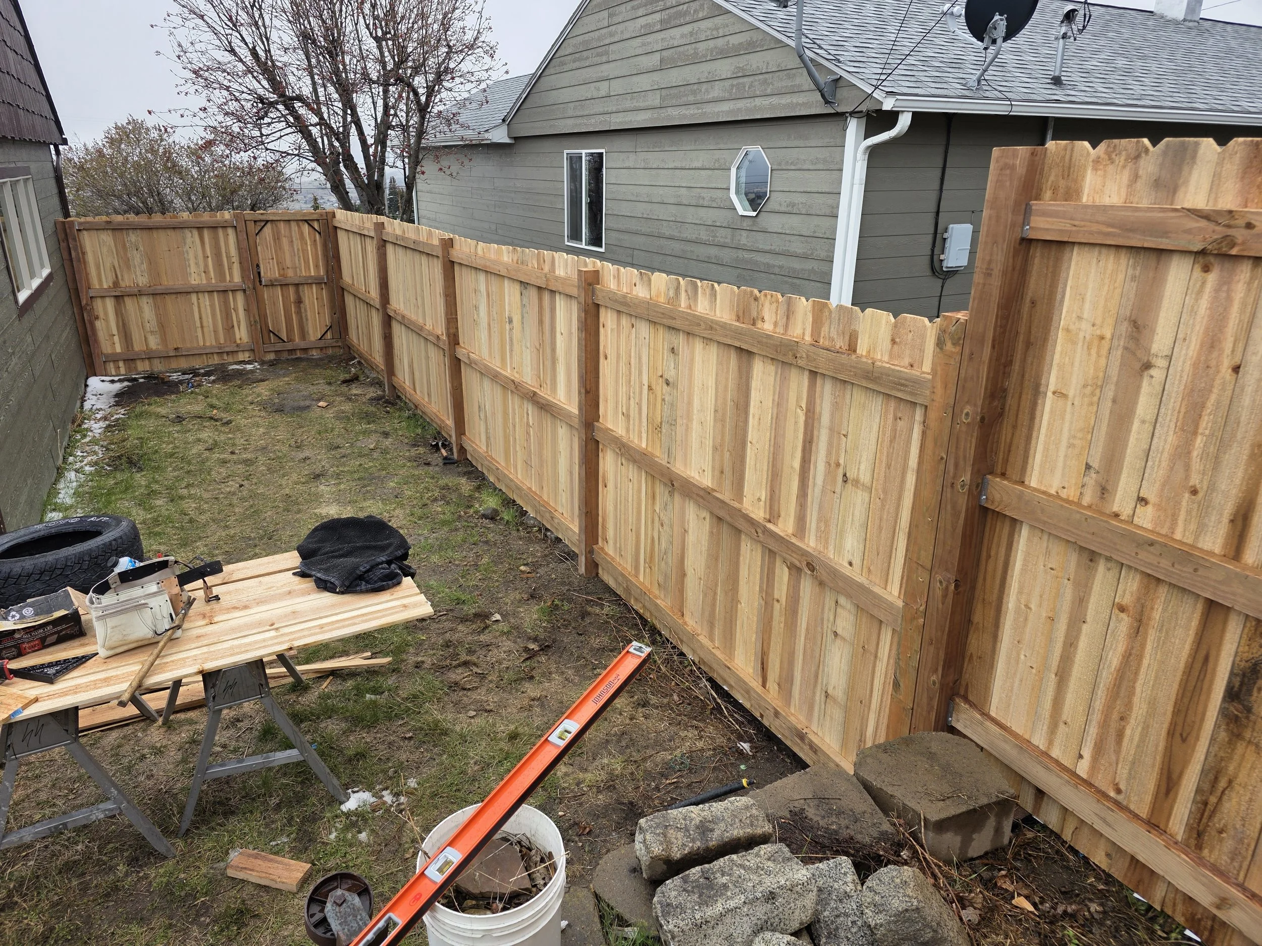 Cedar fence from the yard side during the build, Walkerville, Montana