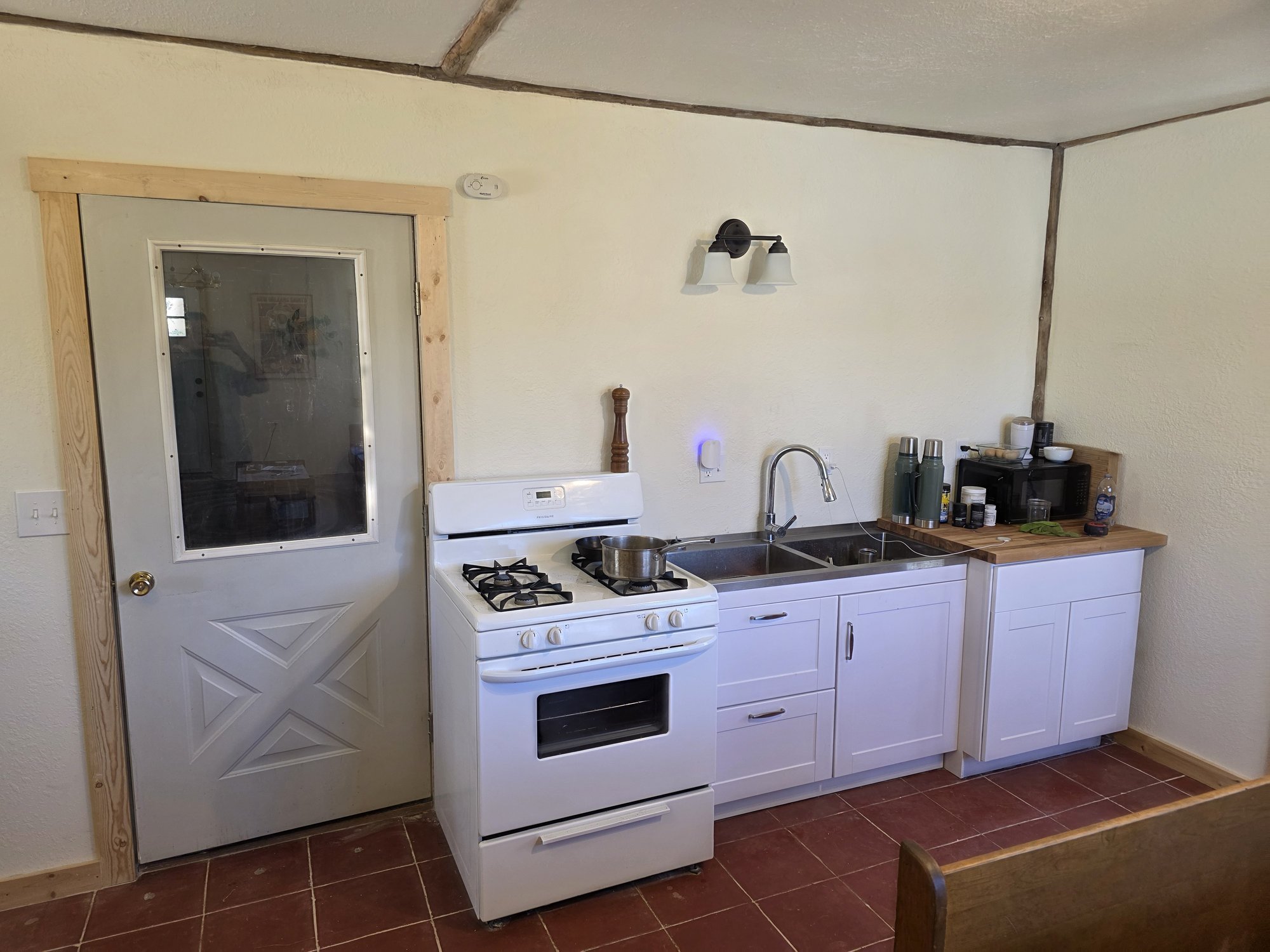 Rebuilt bunkhouse kitchen and new exterior door, Cardwell, Montana