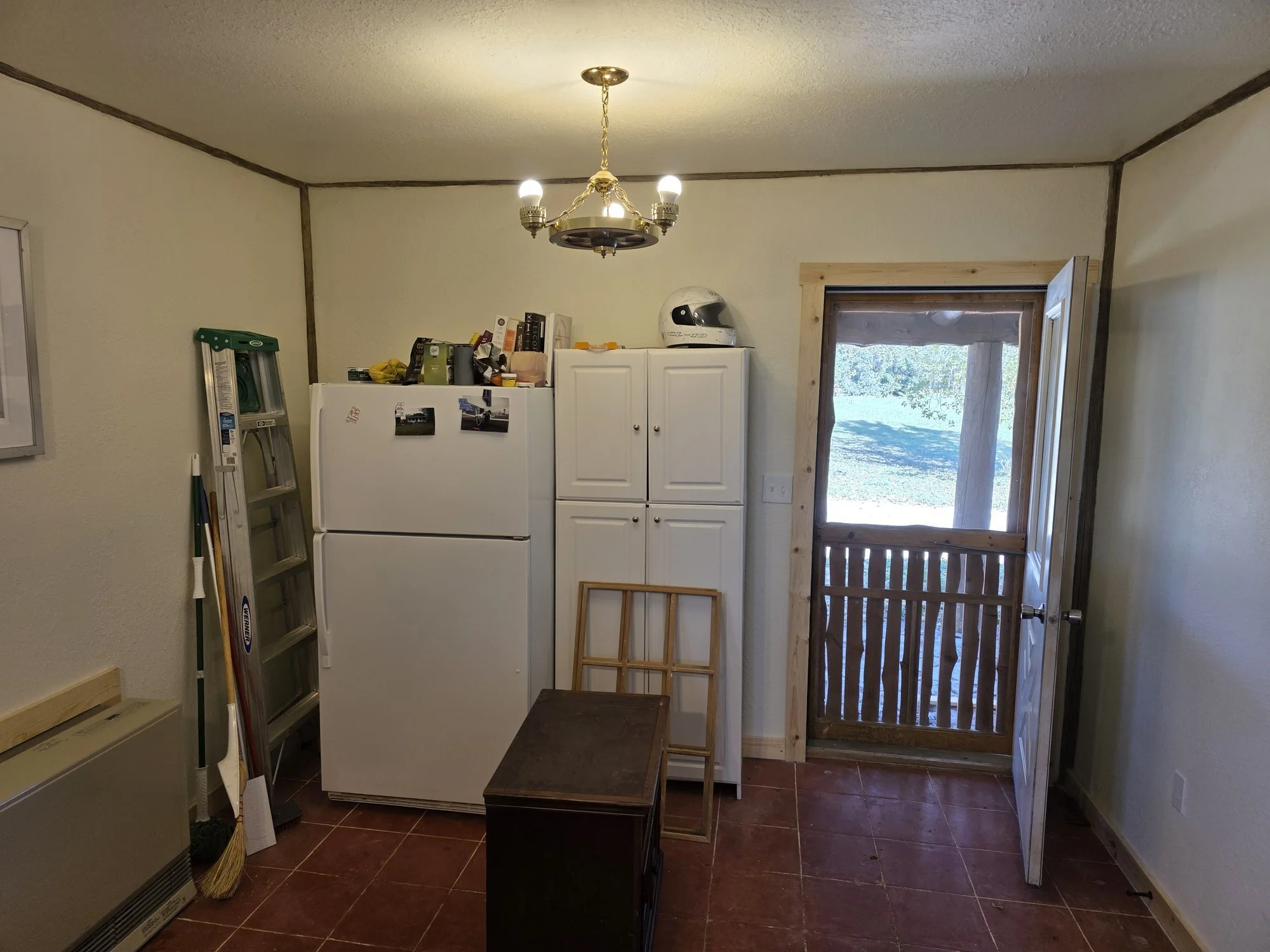 Kitchen door out to the porch in a renovated Cardwell, Montana bunkhouse
