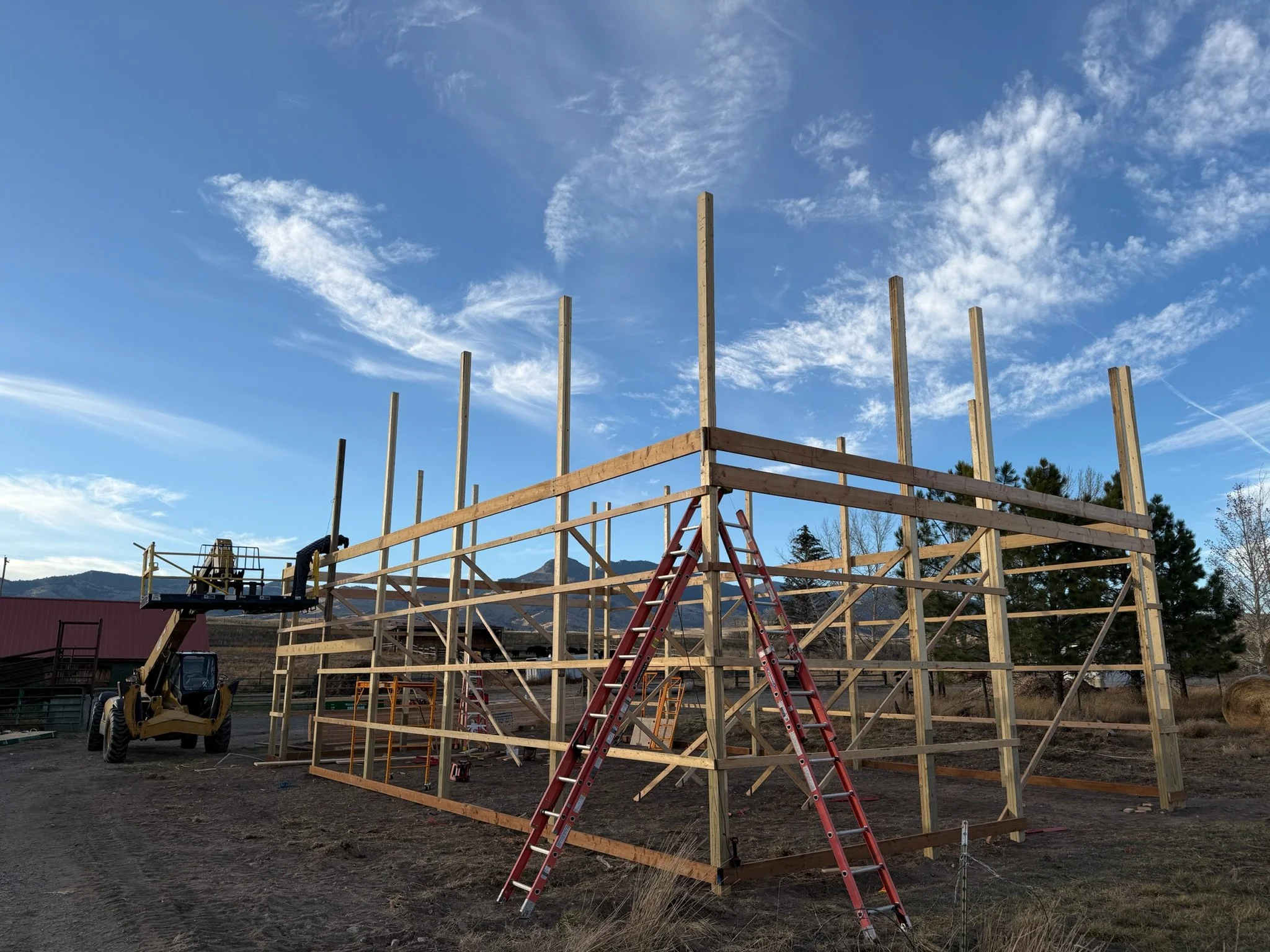 Girts and headers going up on the 40x60 pole barn frame, Cardwell, Montana