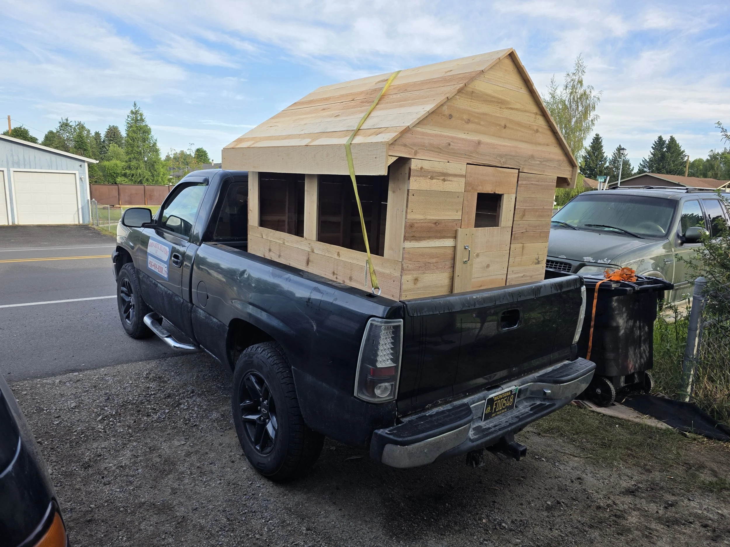 Cedar playhouse loaded in the truck bed for delivery
