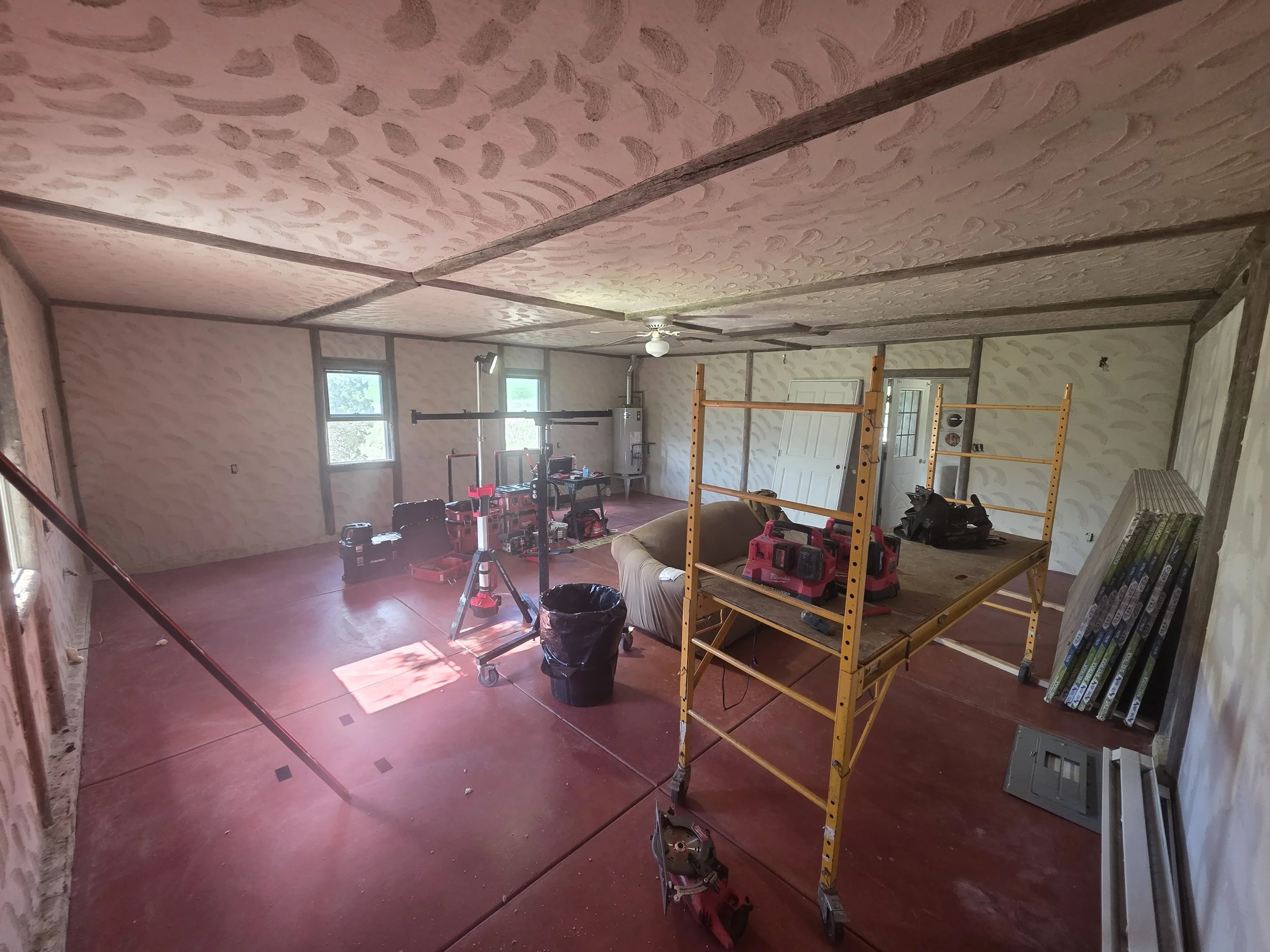 Before: the Cardwell, Montana bunkhouse as one open room with plaster walls, scaffolding set up for the ceiling work