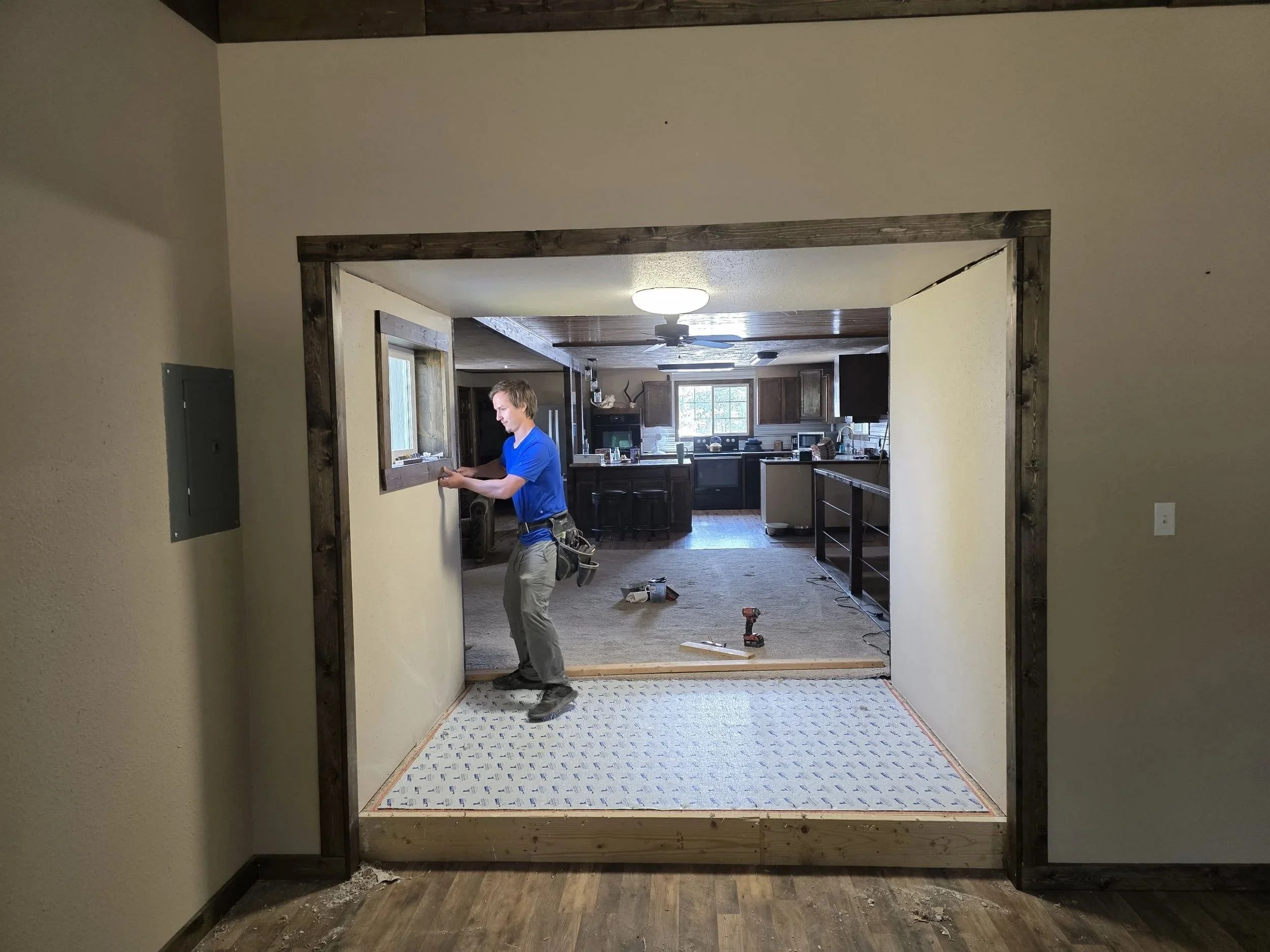 Finished opening with dark-stained trim between the old house and the new room on the Whitehall, MT addition job