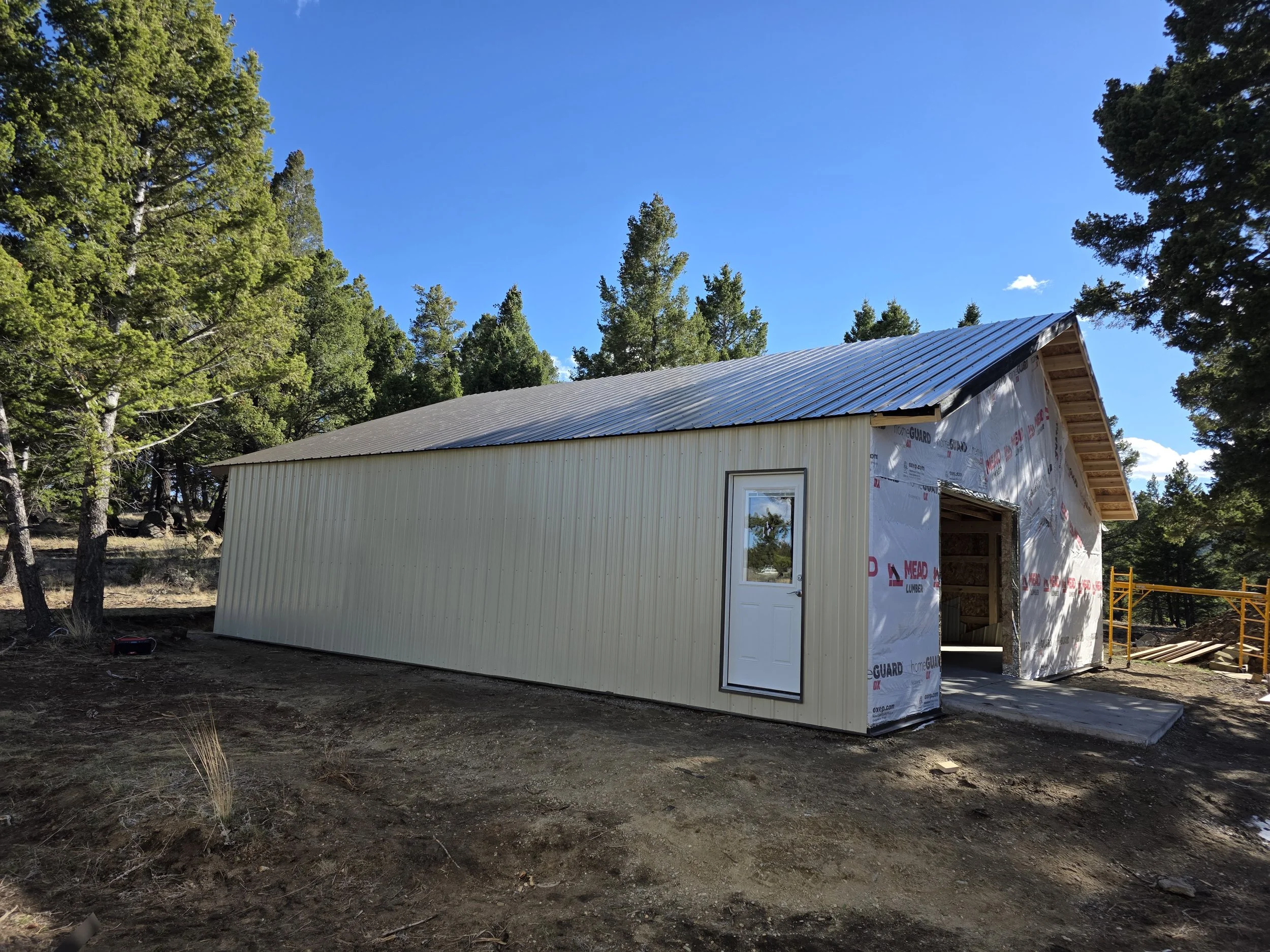 Pole barn shop with the steel roof on and siding going up, Whitehall, Montana