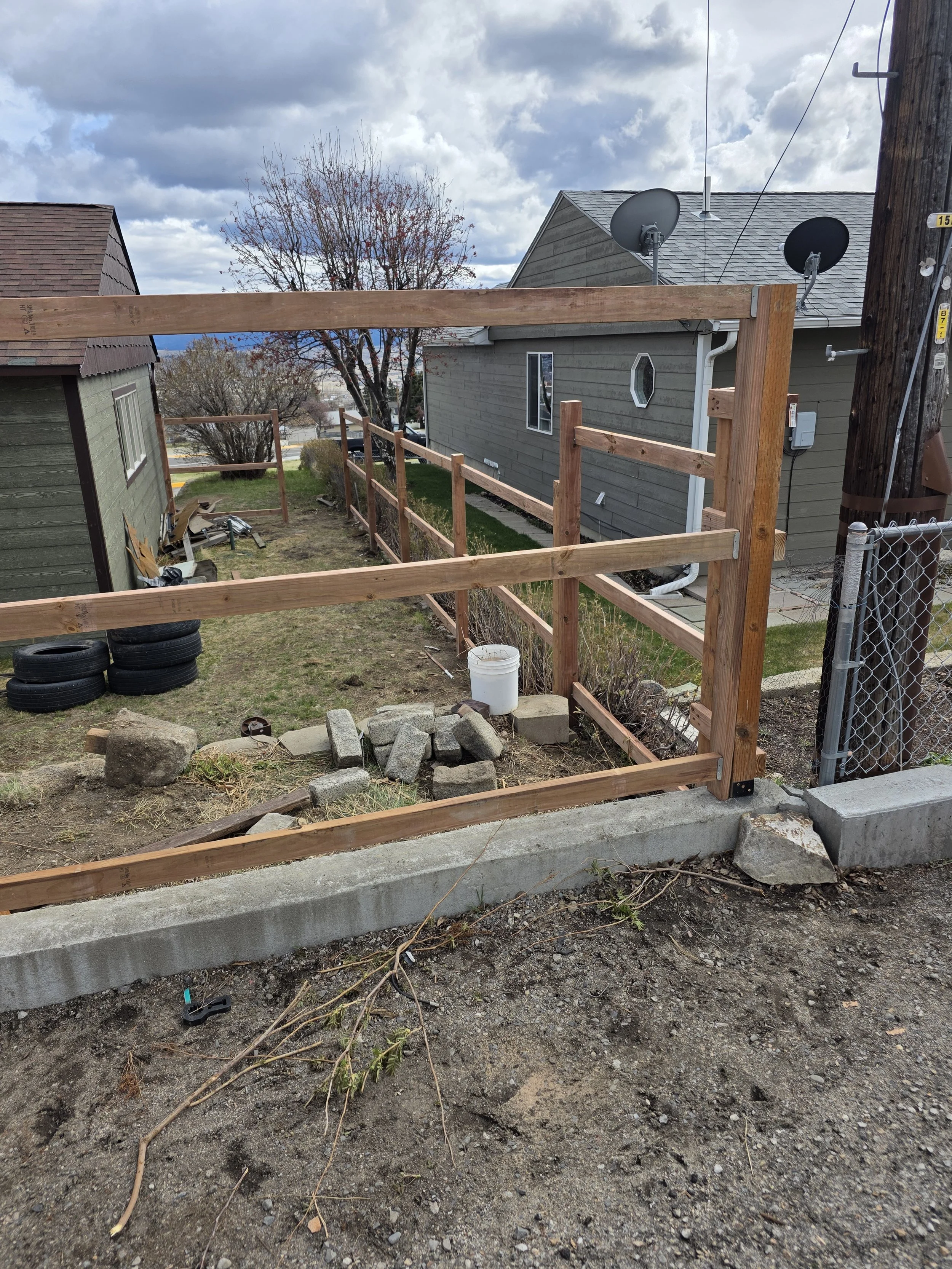 New cedar posts and top rails set along the fence line, Walkerville, Montana