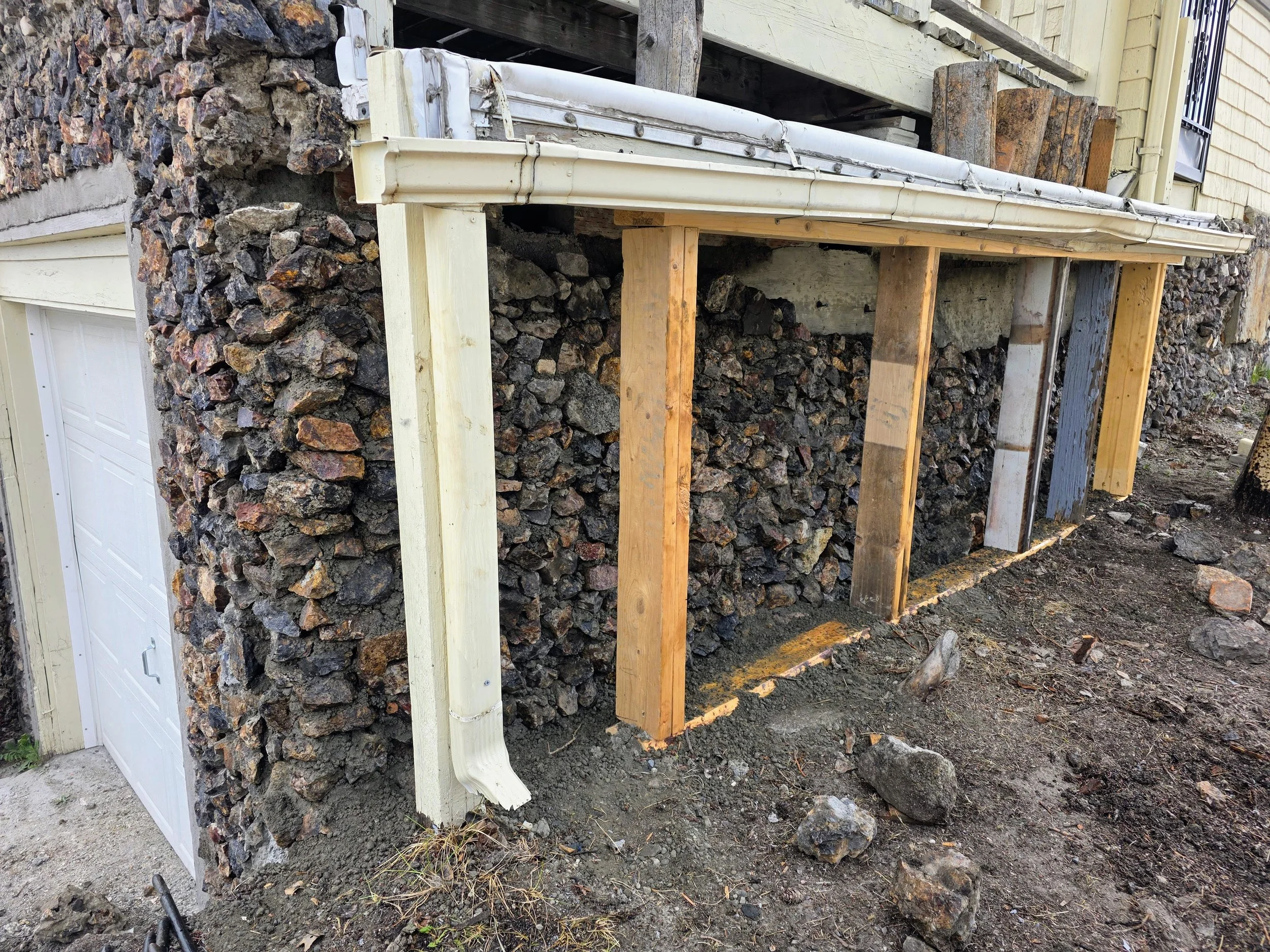 Original stone laid back up against the new concrete wall, Butte, Montana